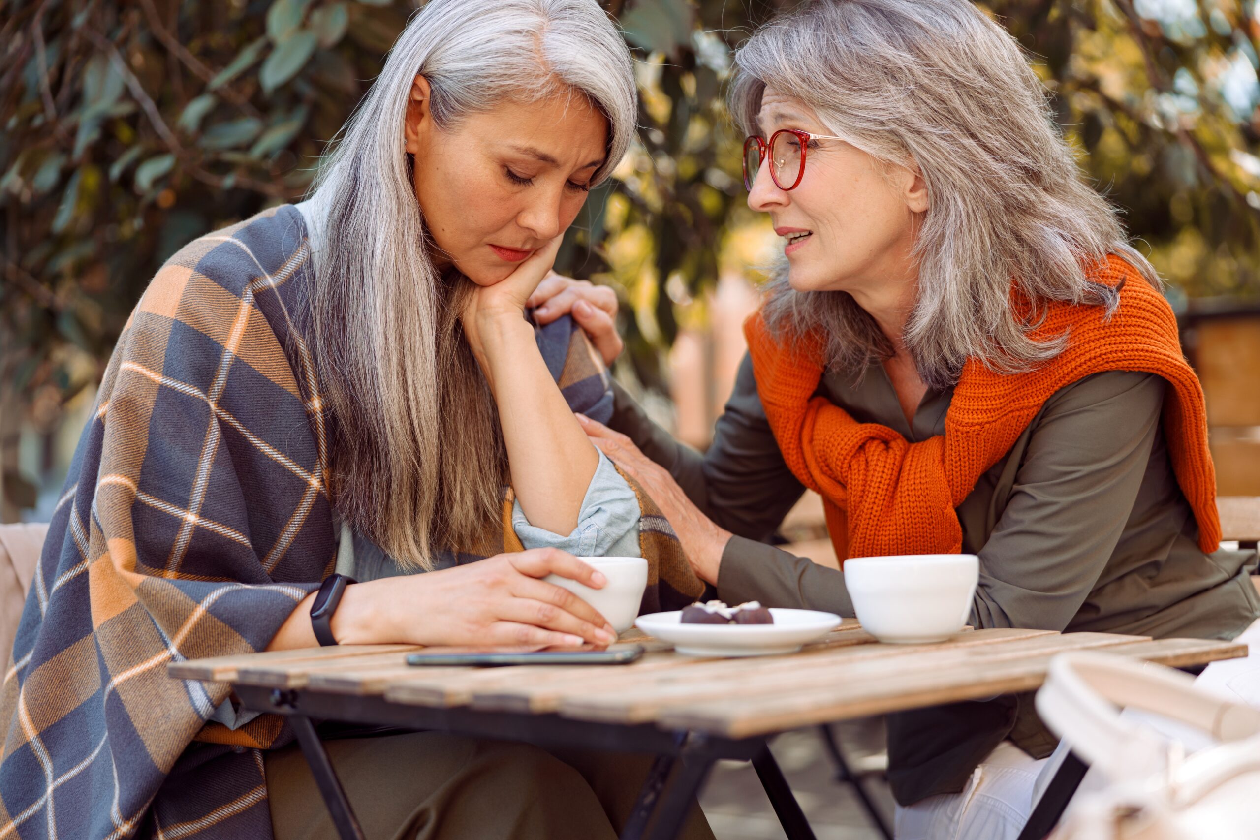Two female friends having a heart to heart conversation.