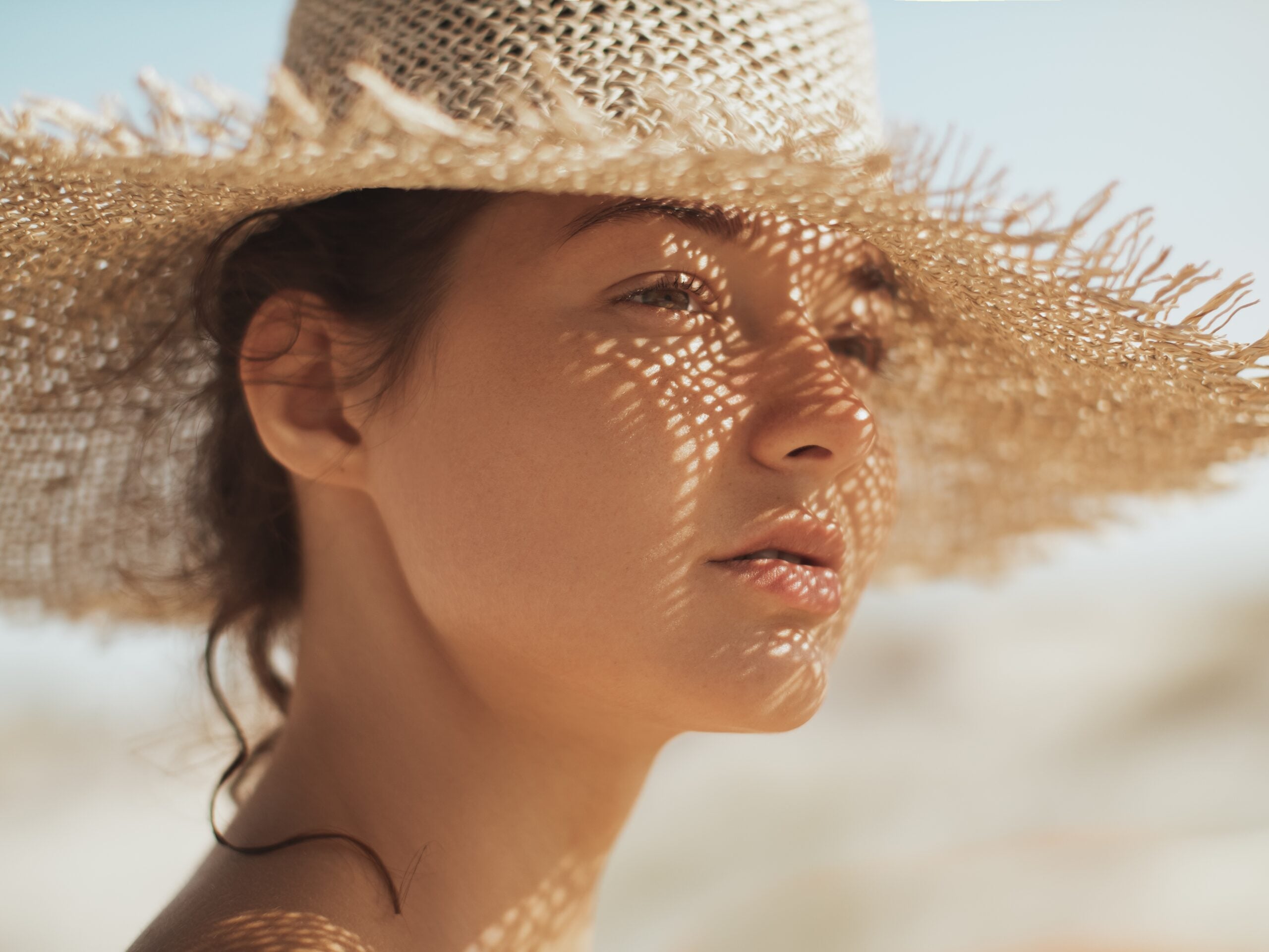 A young woman enjoying her beach vacation without a phone.