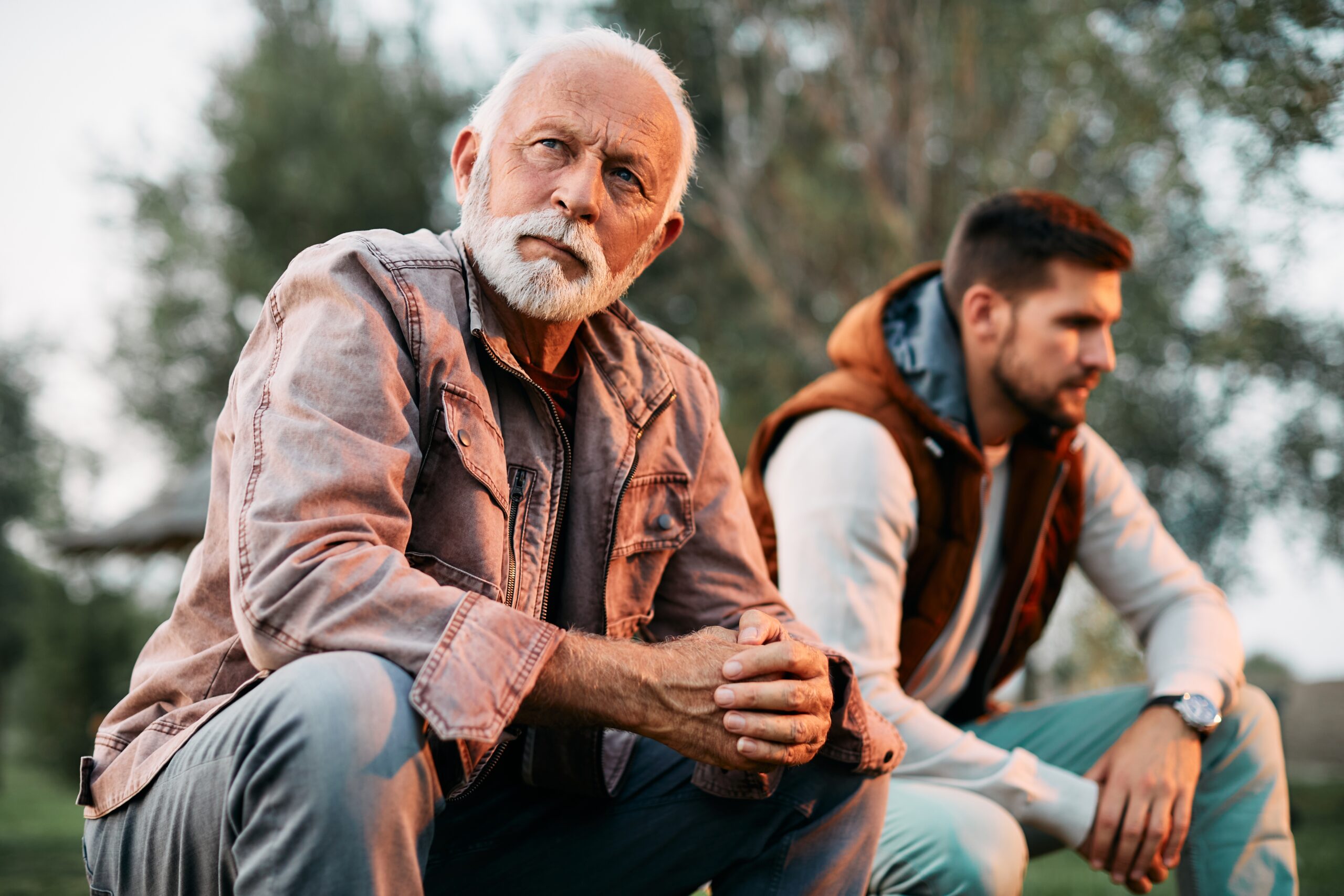 A senior man having a disagreement with his adult son.