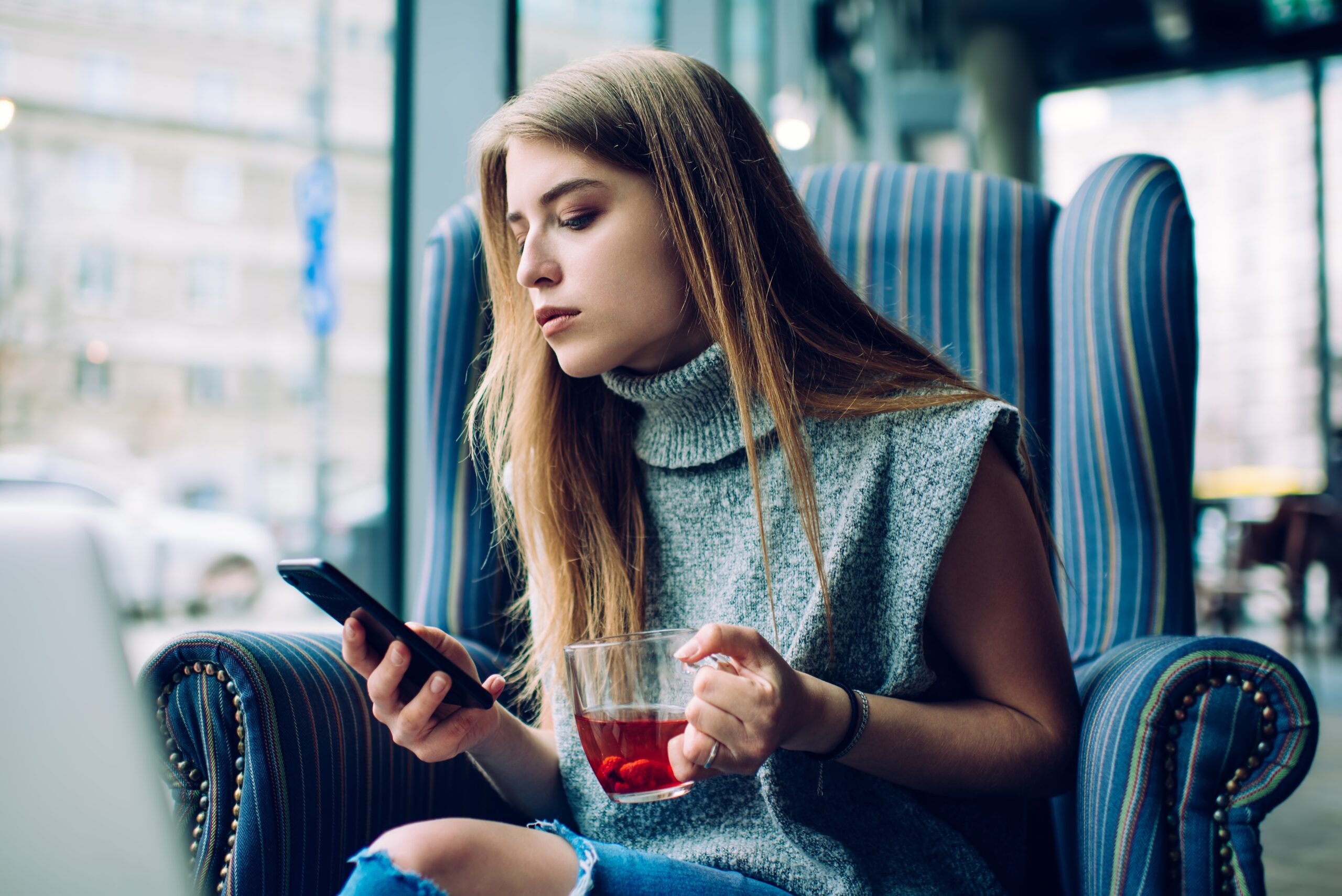 A confident young woman having a coffee alone.