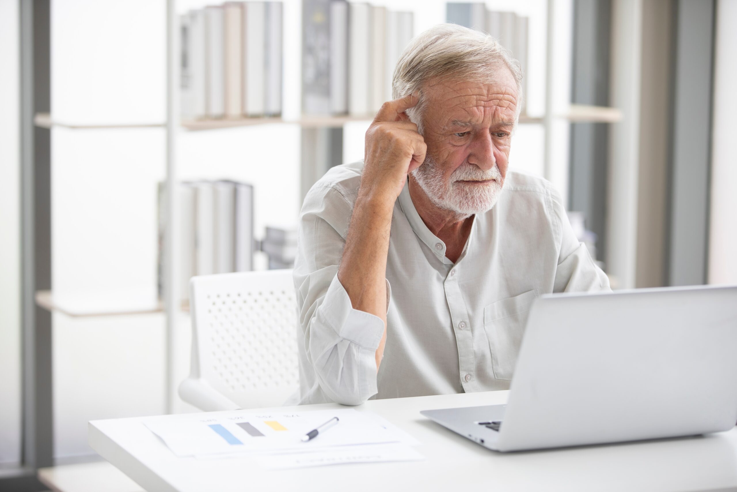 A boomer man sitting at his computer.