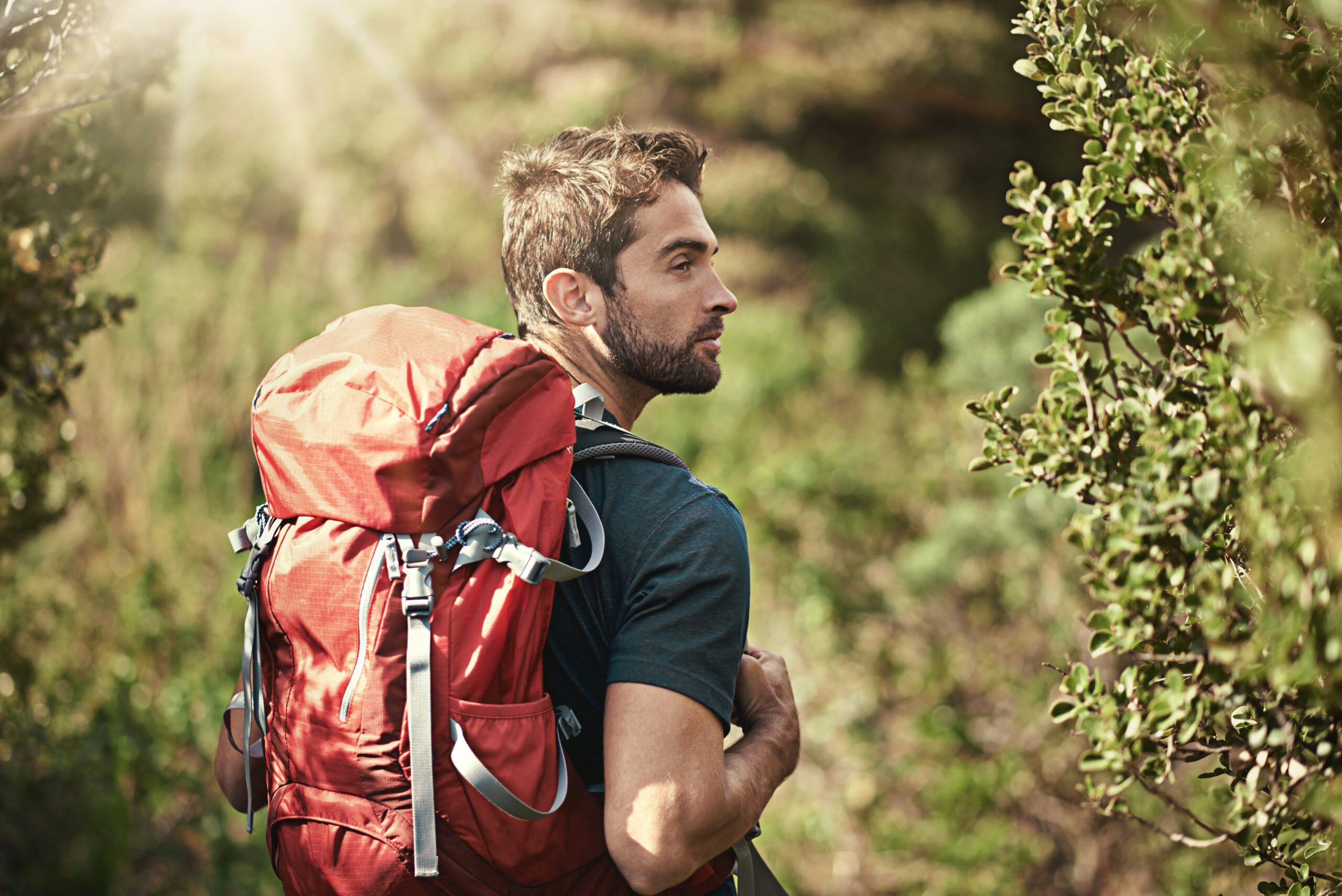A man hiking alone in the woods.