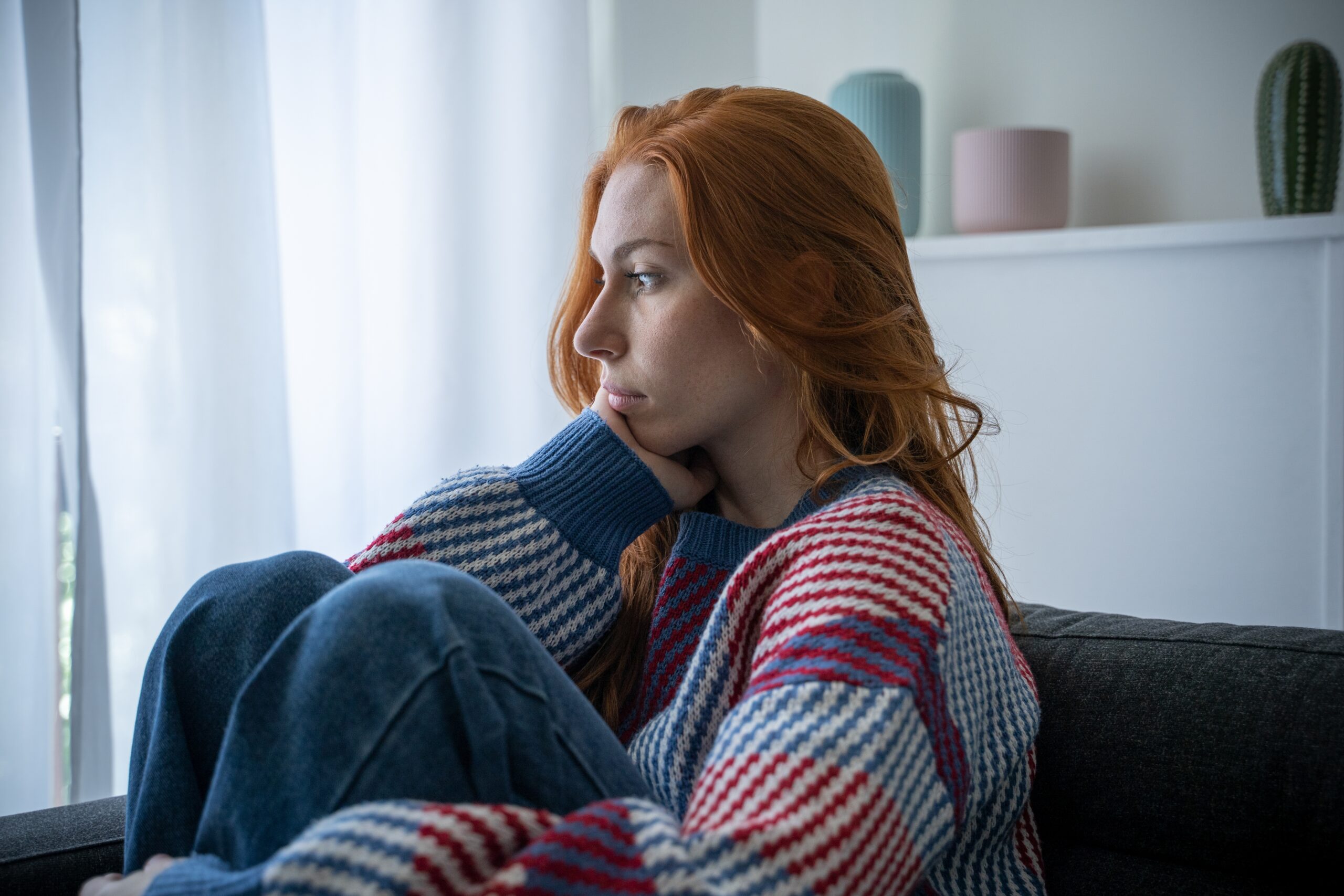 A lonely woman sitting alone while thinking.