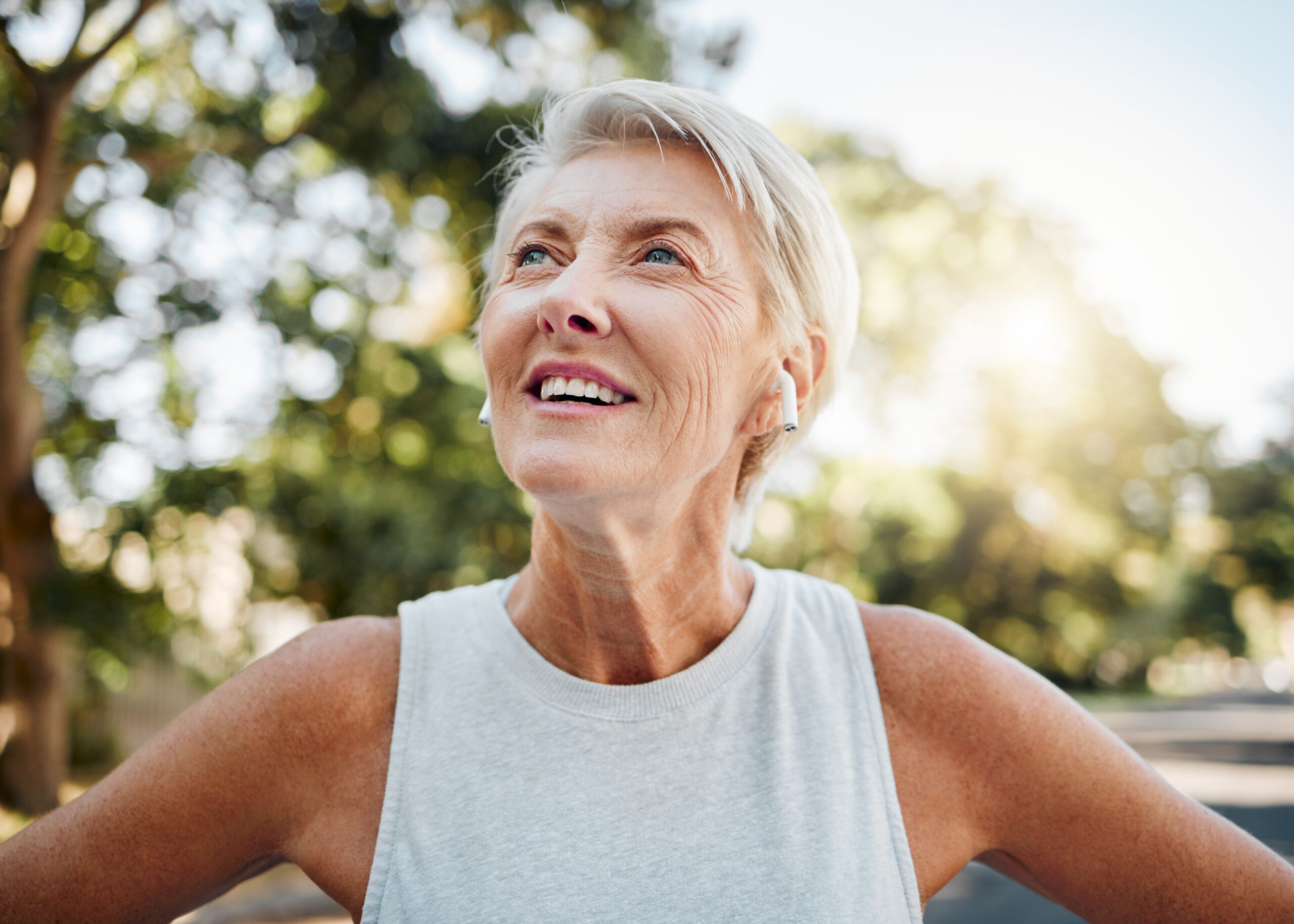 A happy middle aged woman on a morning walk outdoors.