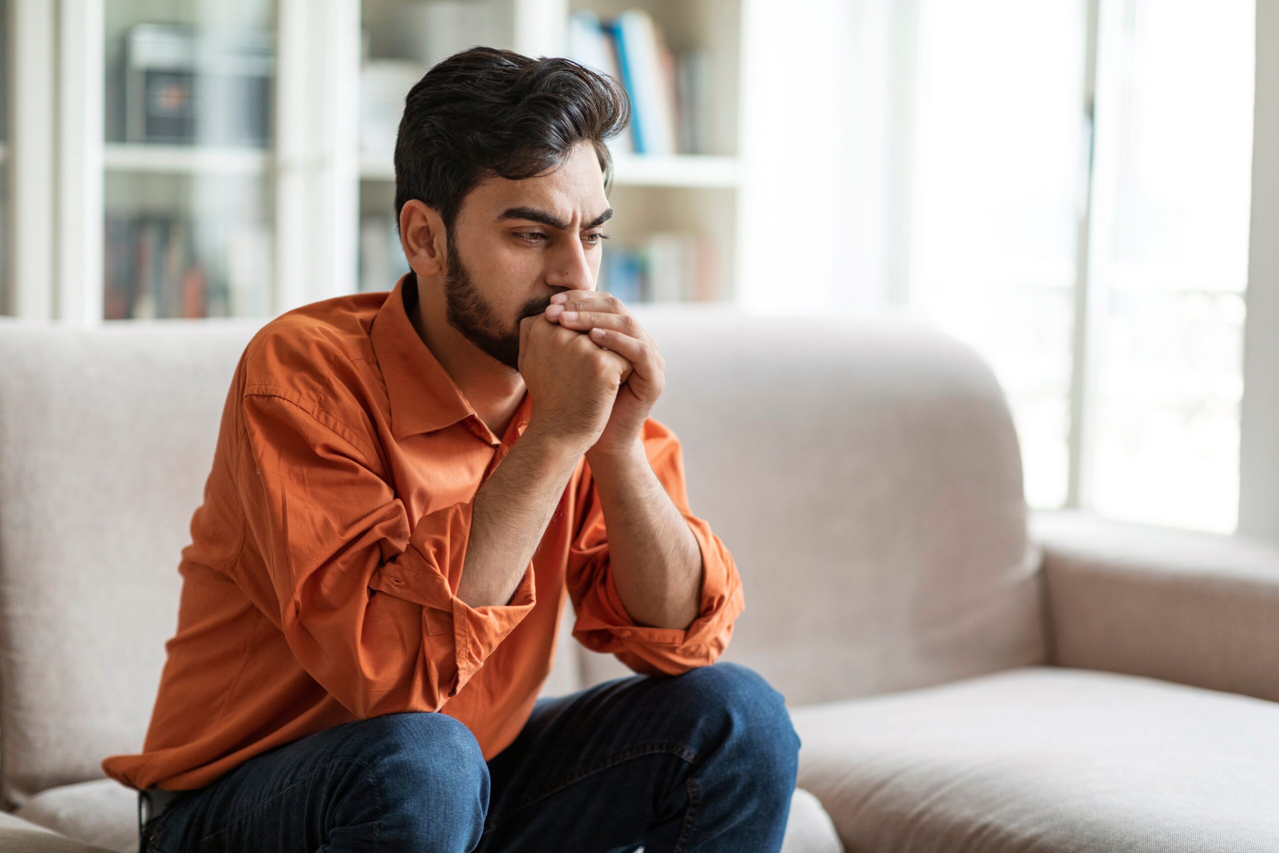 A man thinking negative thoughts.