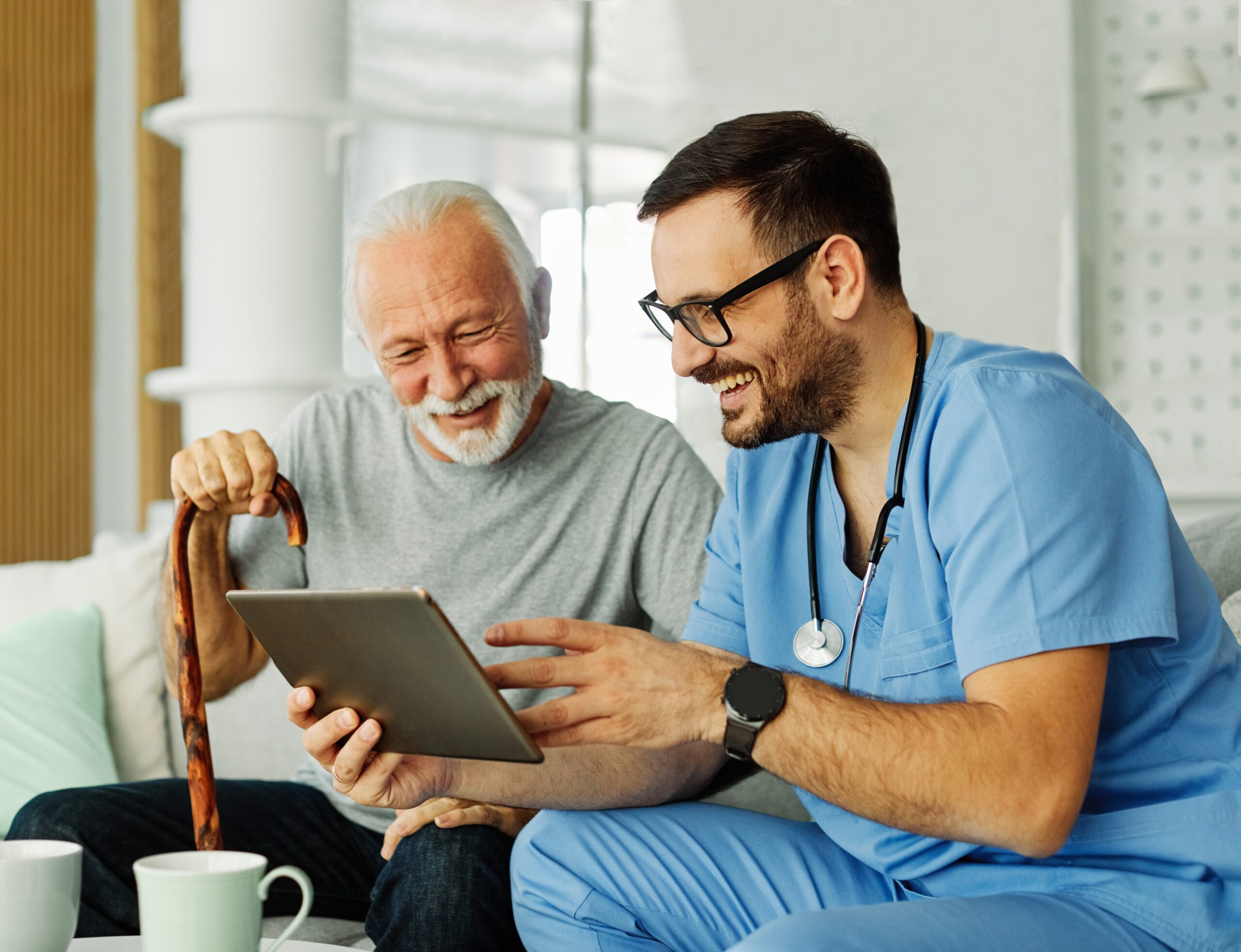 A senior patient laughing with his doctor.