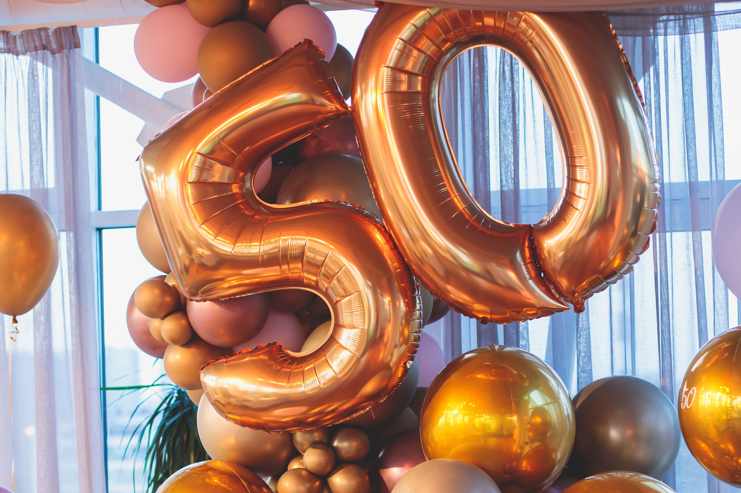 A bunch of balloons including the number 50.