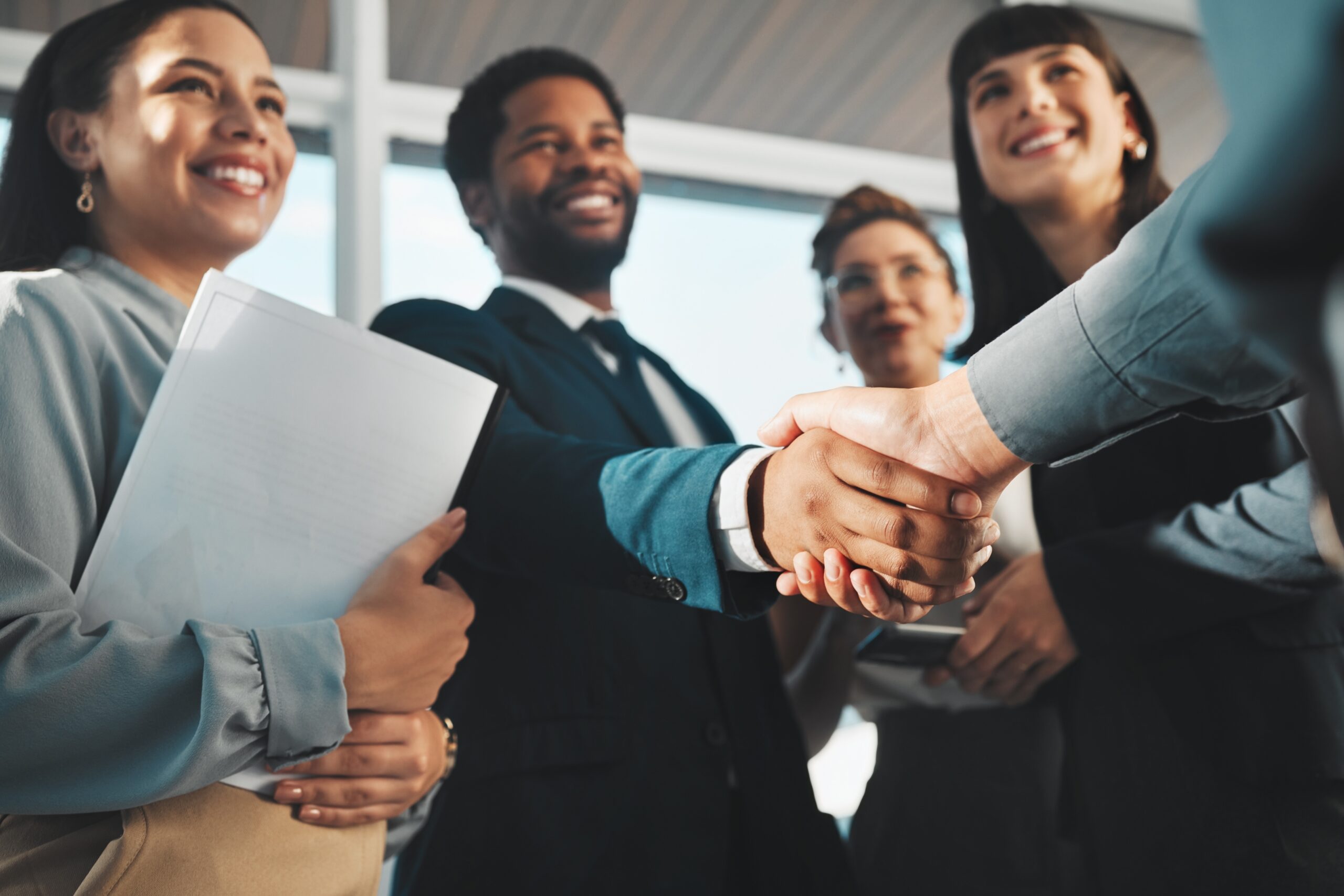 A man being congratulated on a promotion at work.