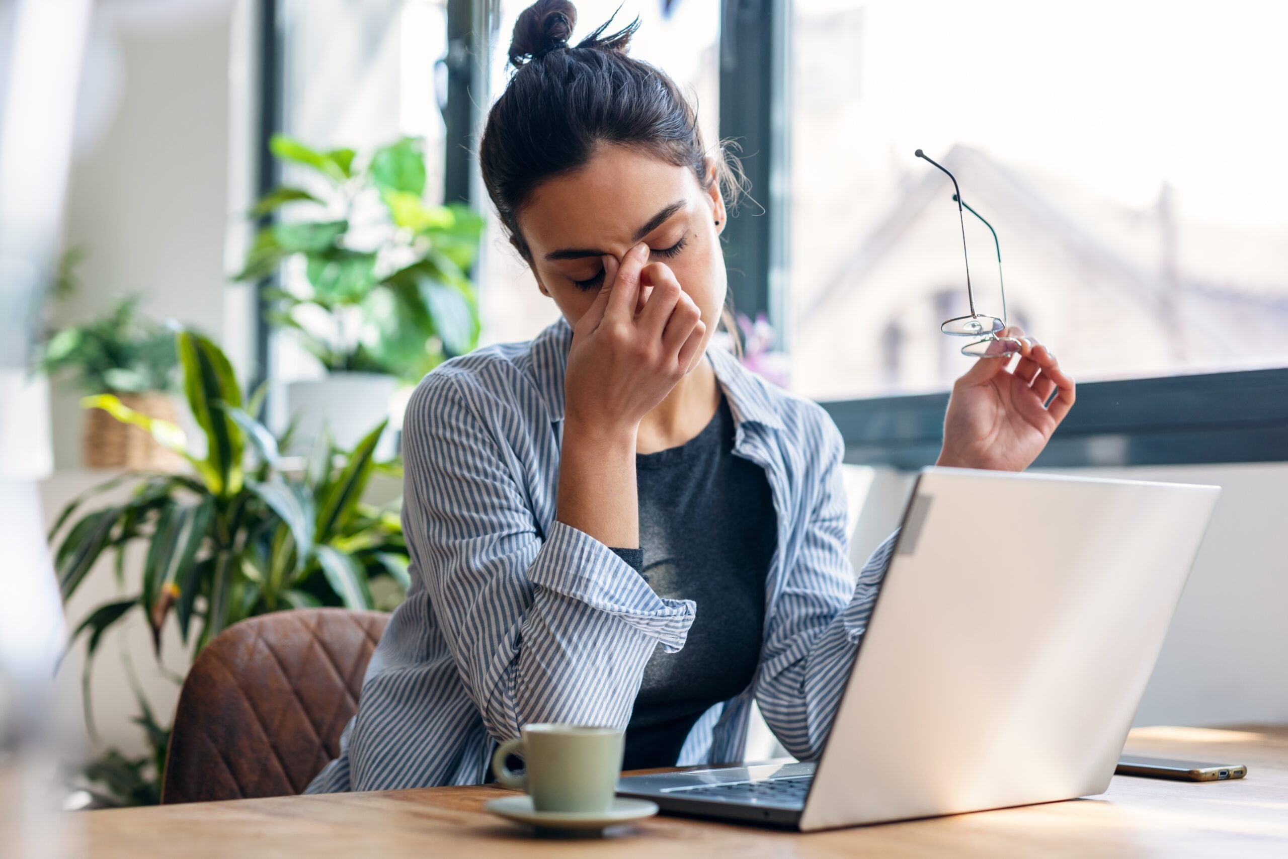 A woman feeling stressed over circumstances at work.