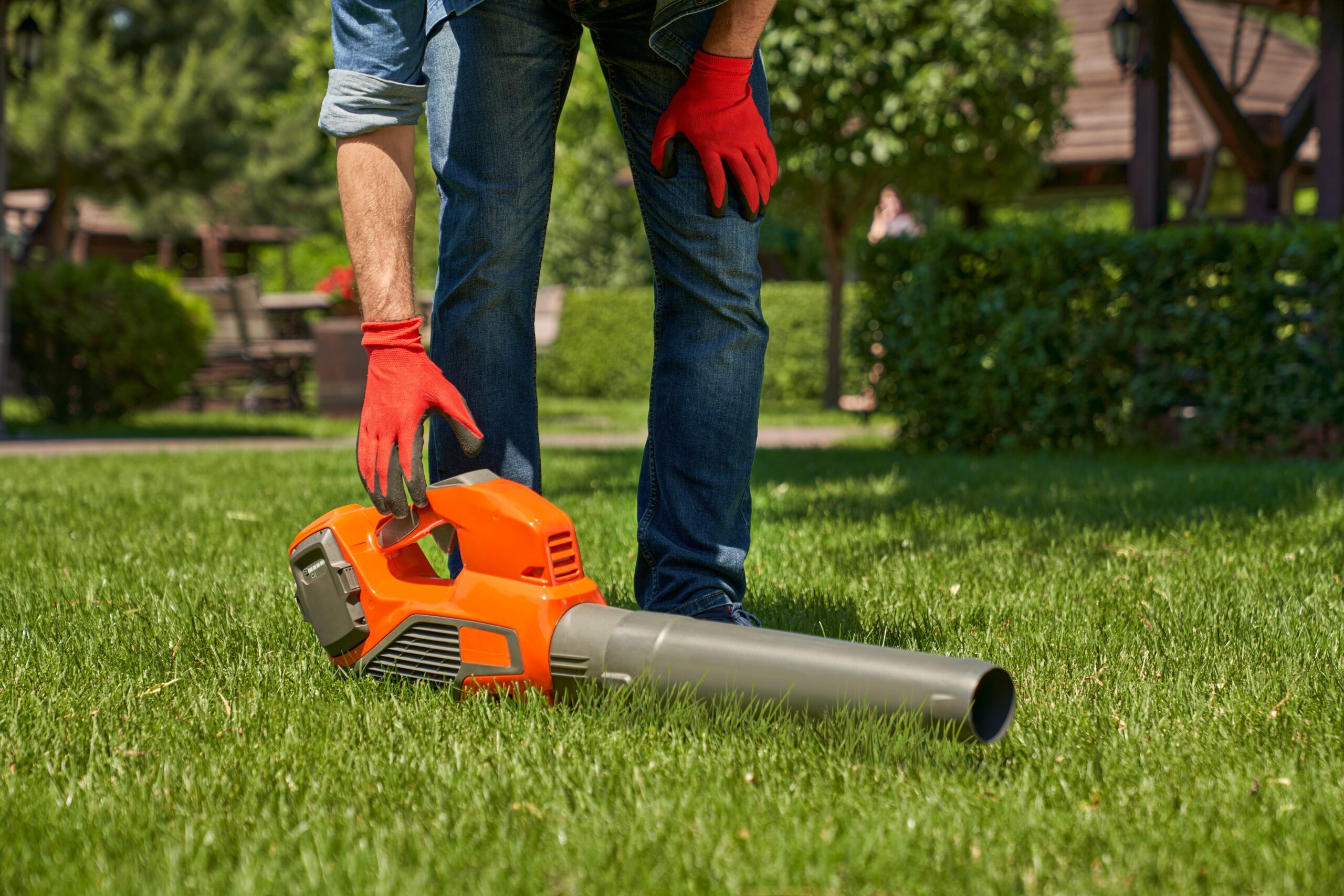 A man using a leaf blower on his day off from work.
