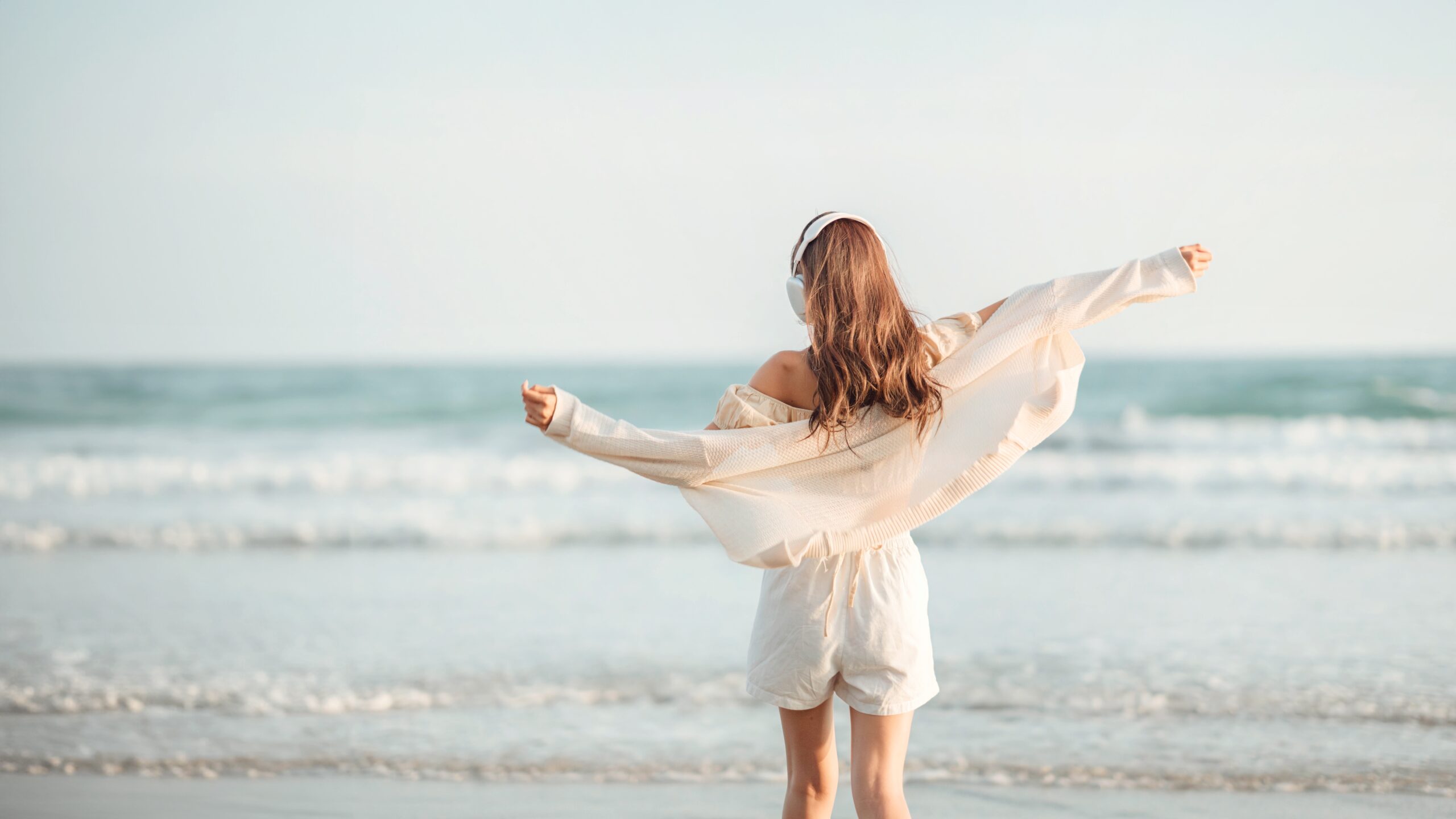 A women enjoying a solo beach walk.