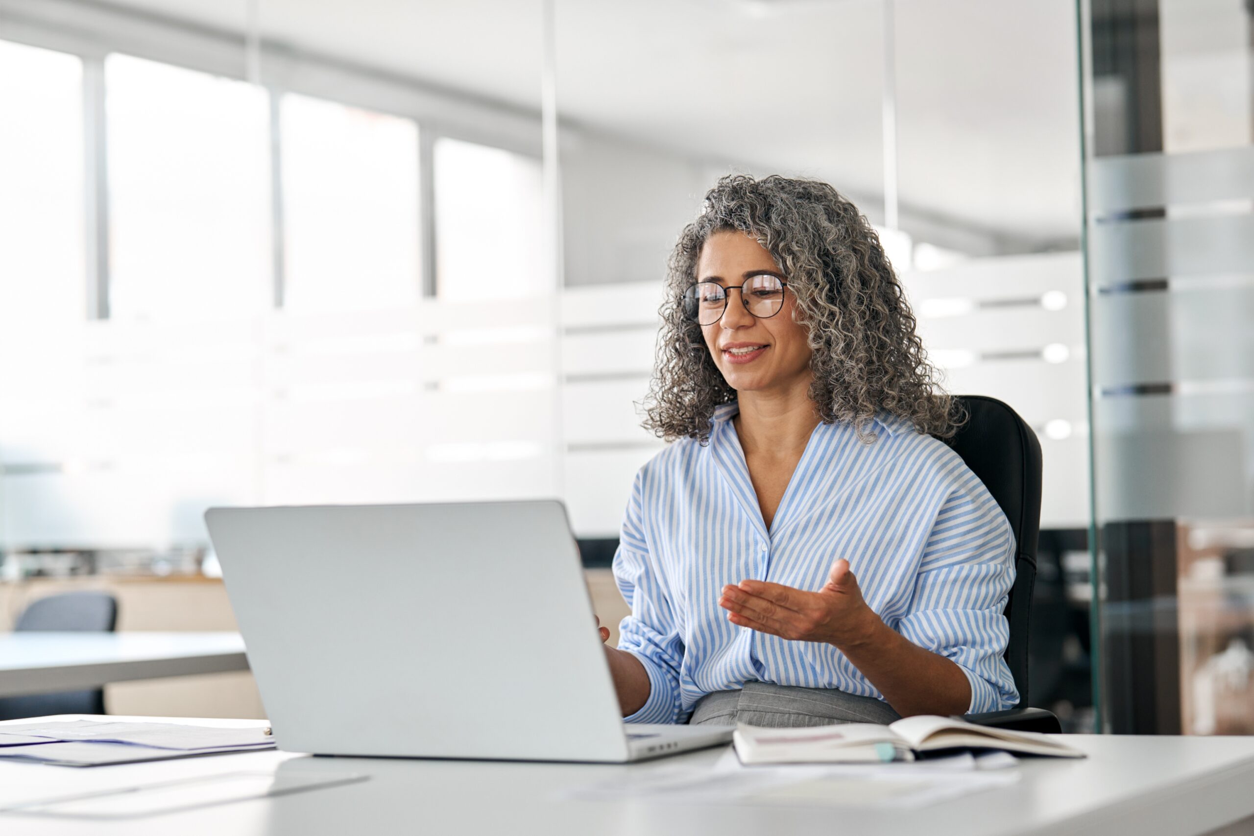 A middle aged business woman conducting a work meeting.