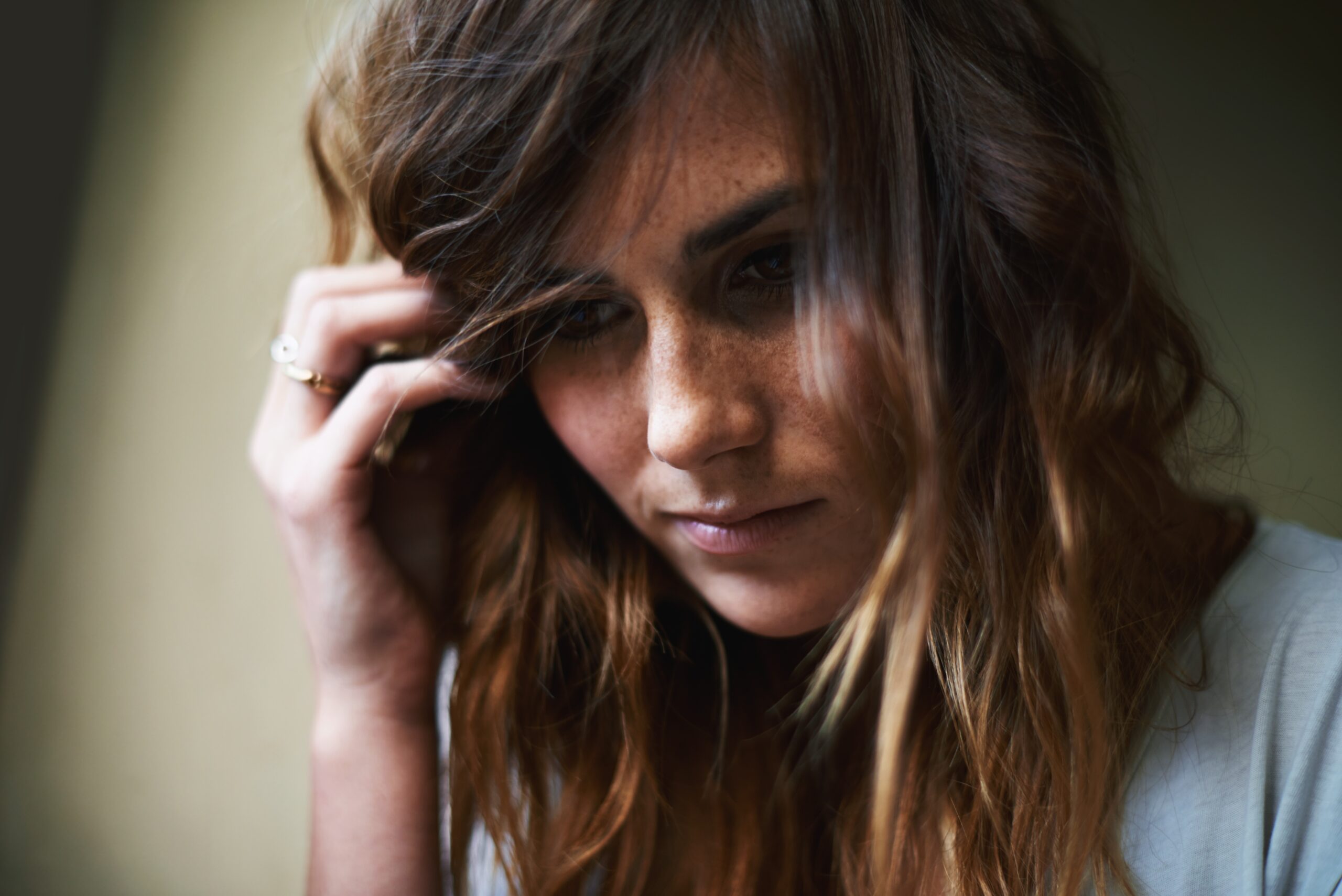 A woman feeling lonely sitting alone with her thoughts.