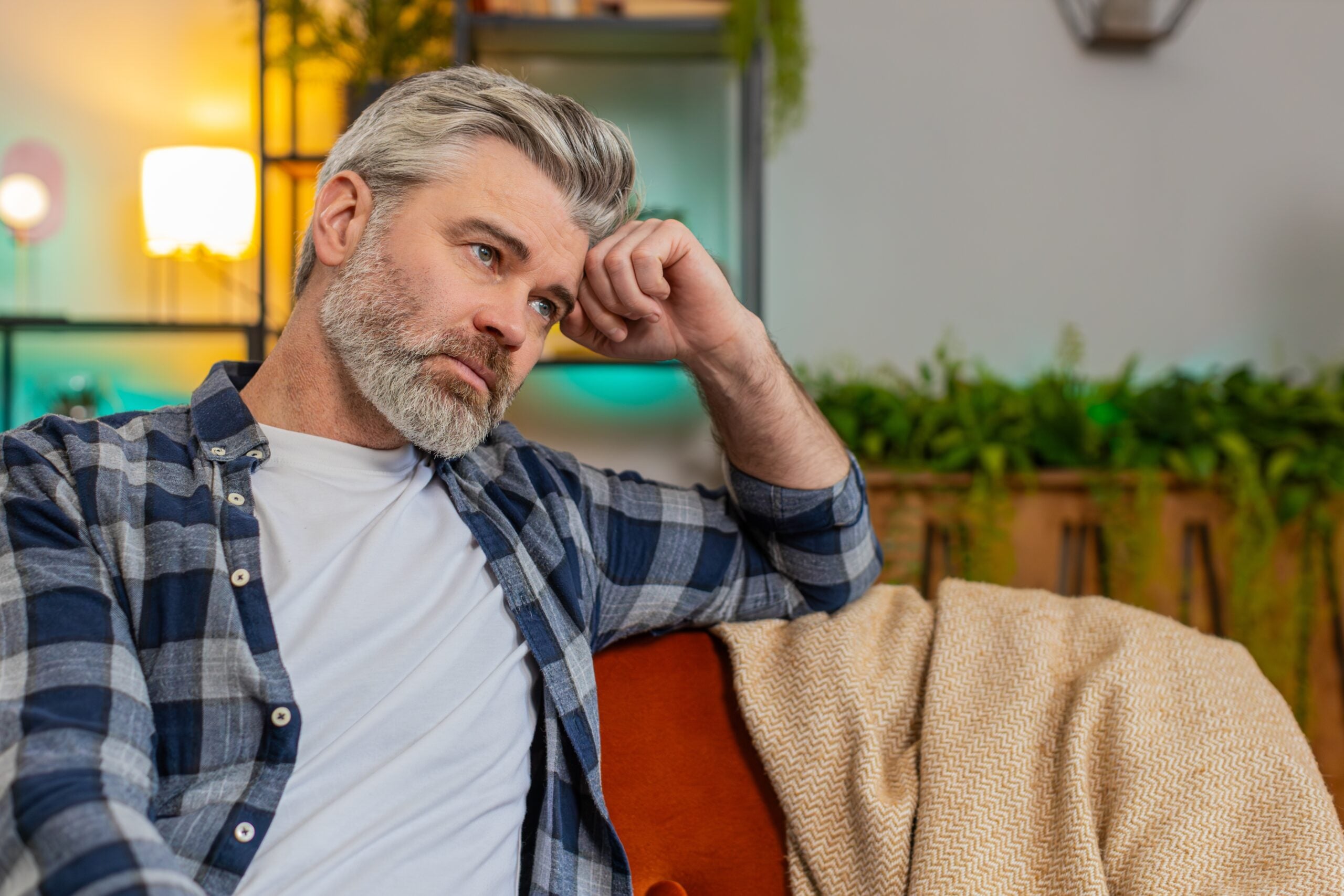 A middle aged man having a quiet afternoon of thinking.