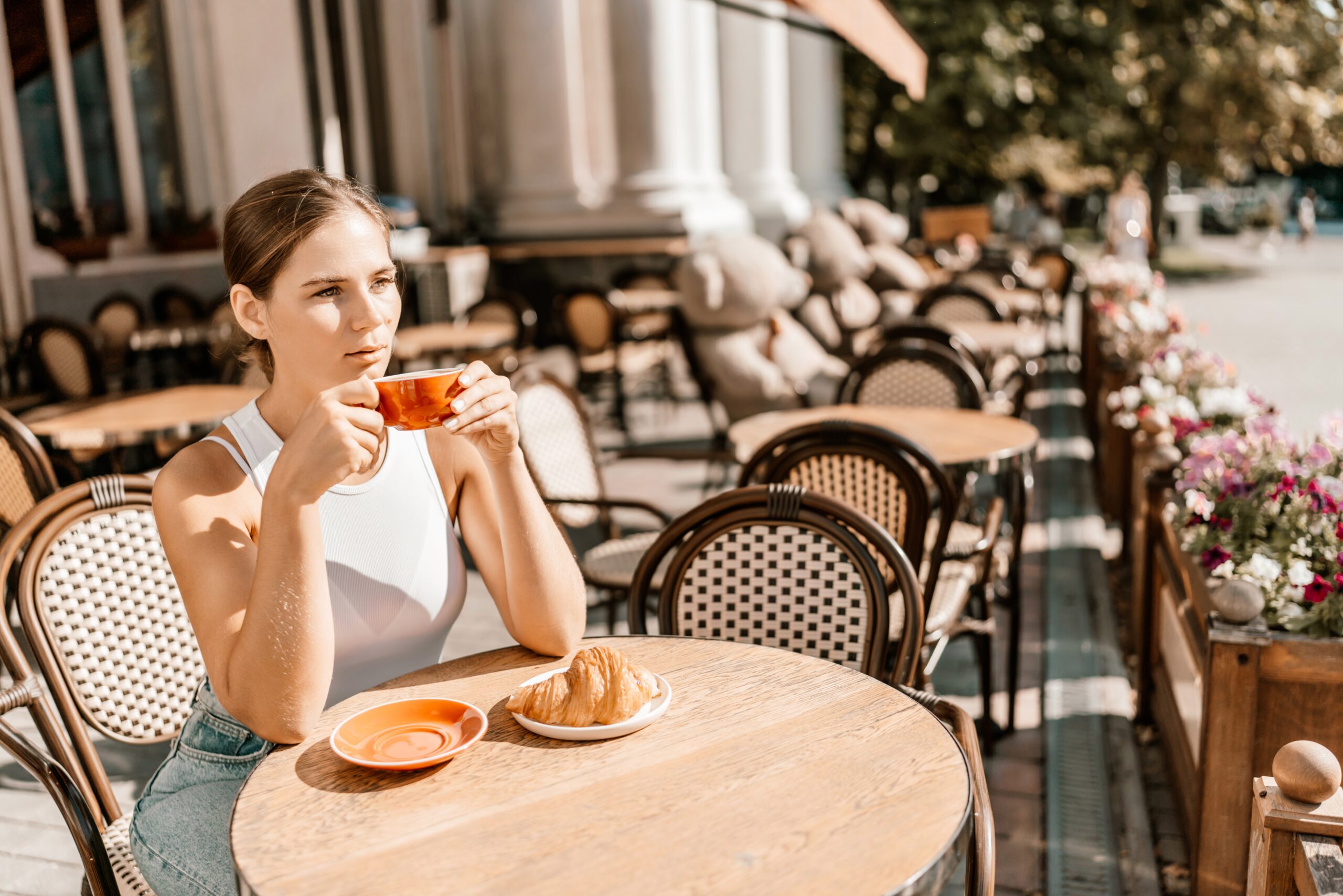 A woman having breakfast alone at a cafe.