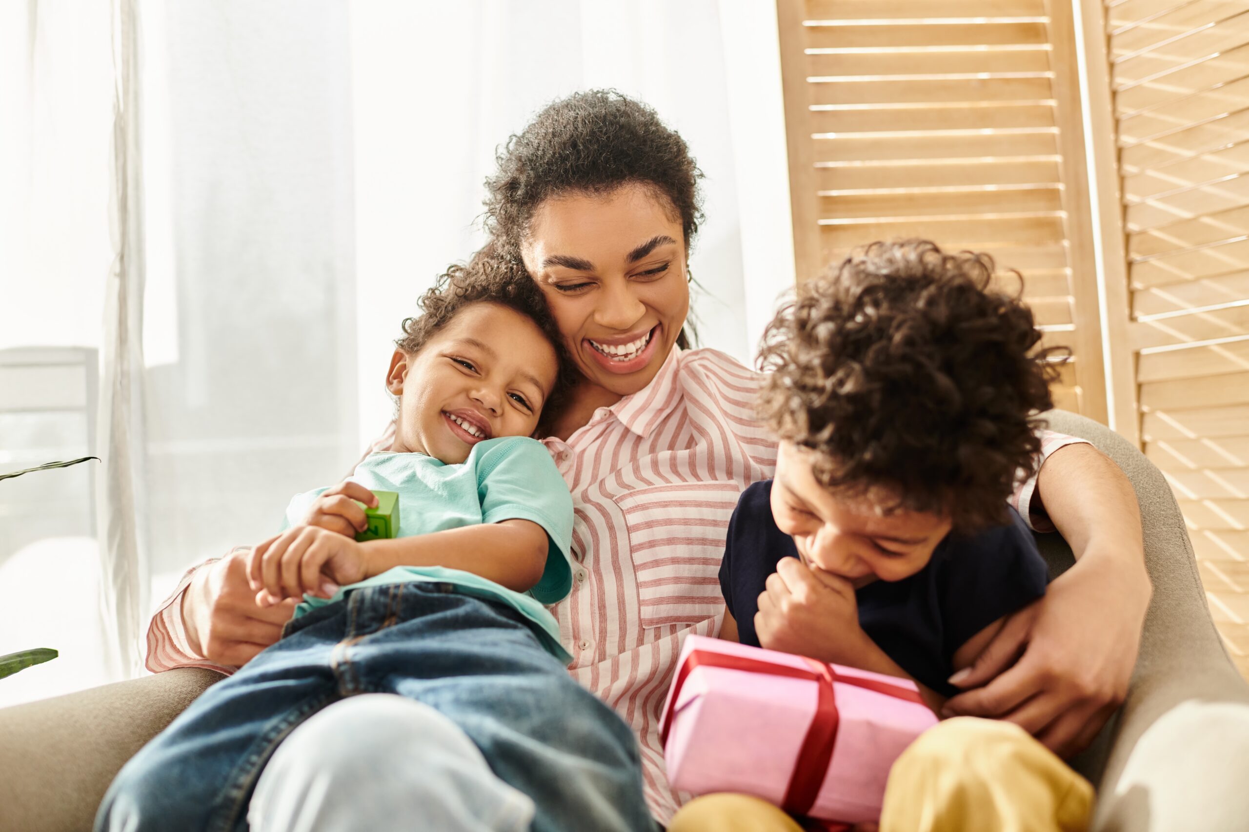 A happy young mother playing with her children.