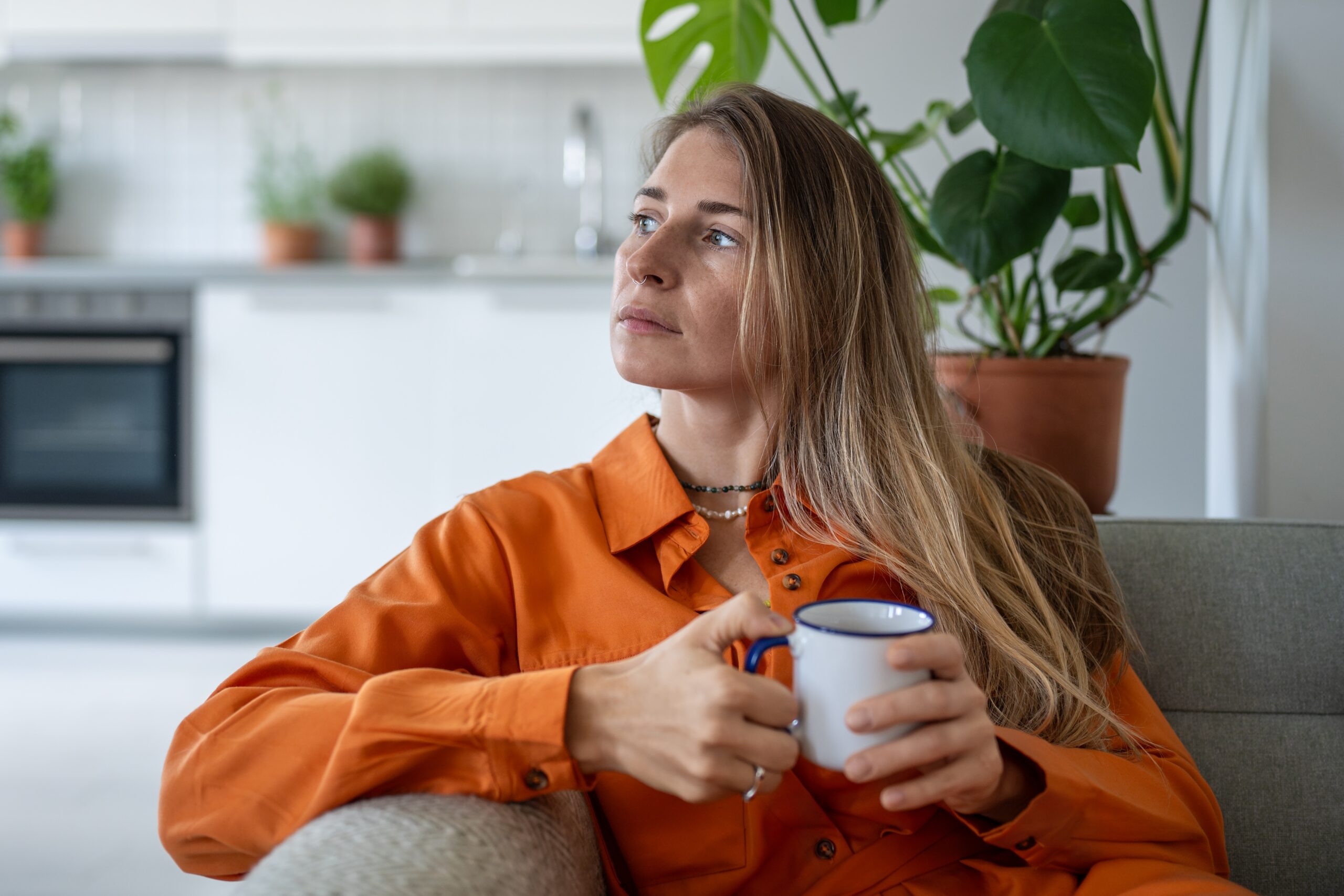 A confident but serious woman having coffee.