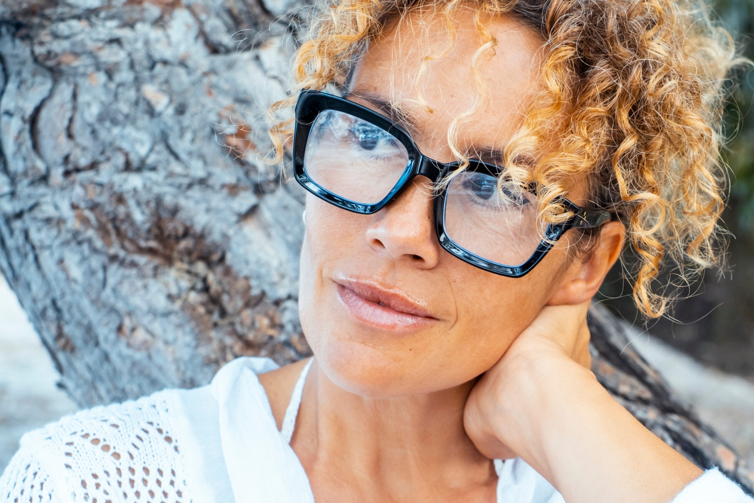 Middle aged woman sitting alone deep in thought.