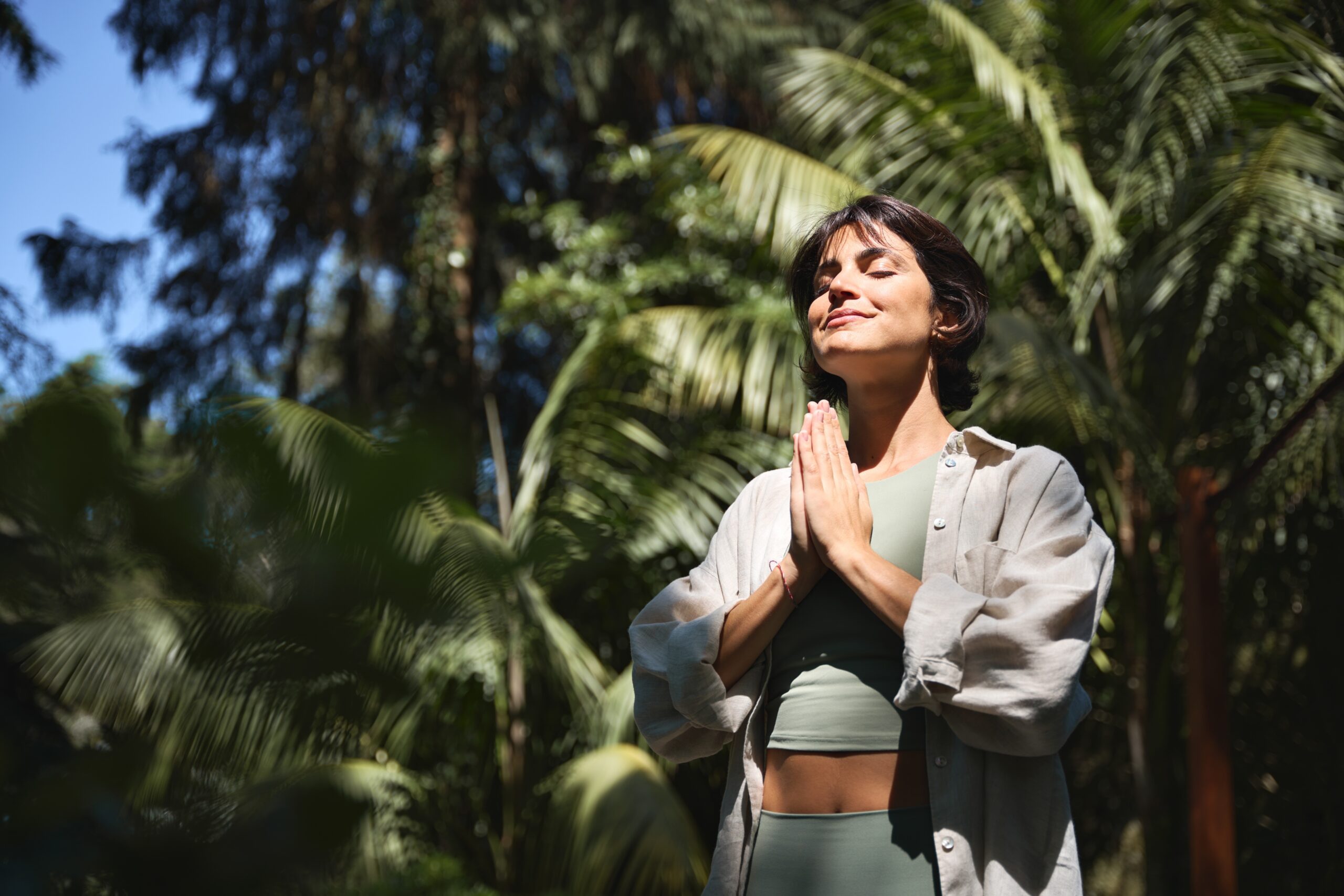 A confident woman practicing outdoor meditation.