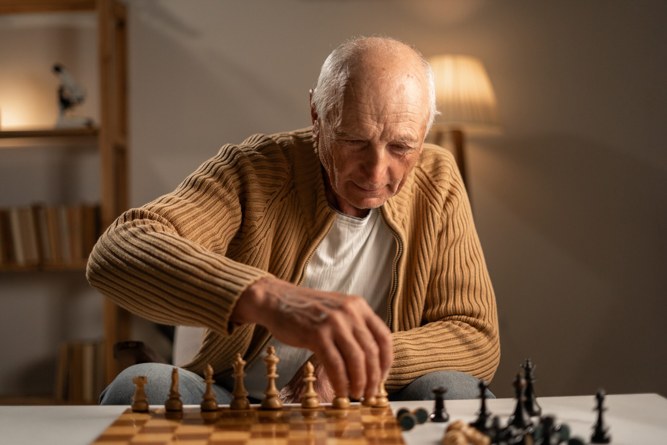 A senior man playing chess.