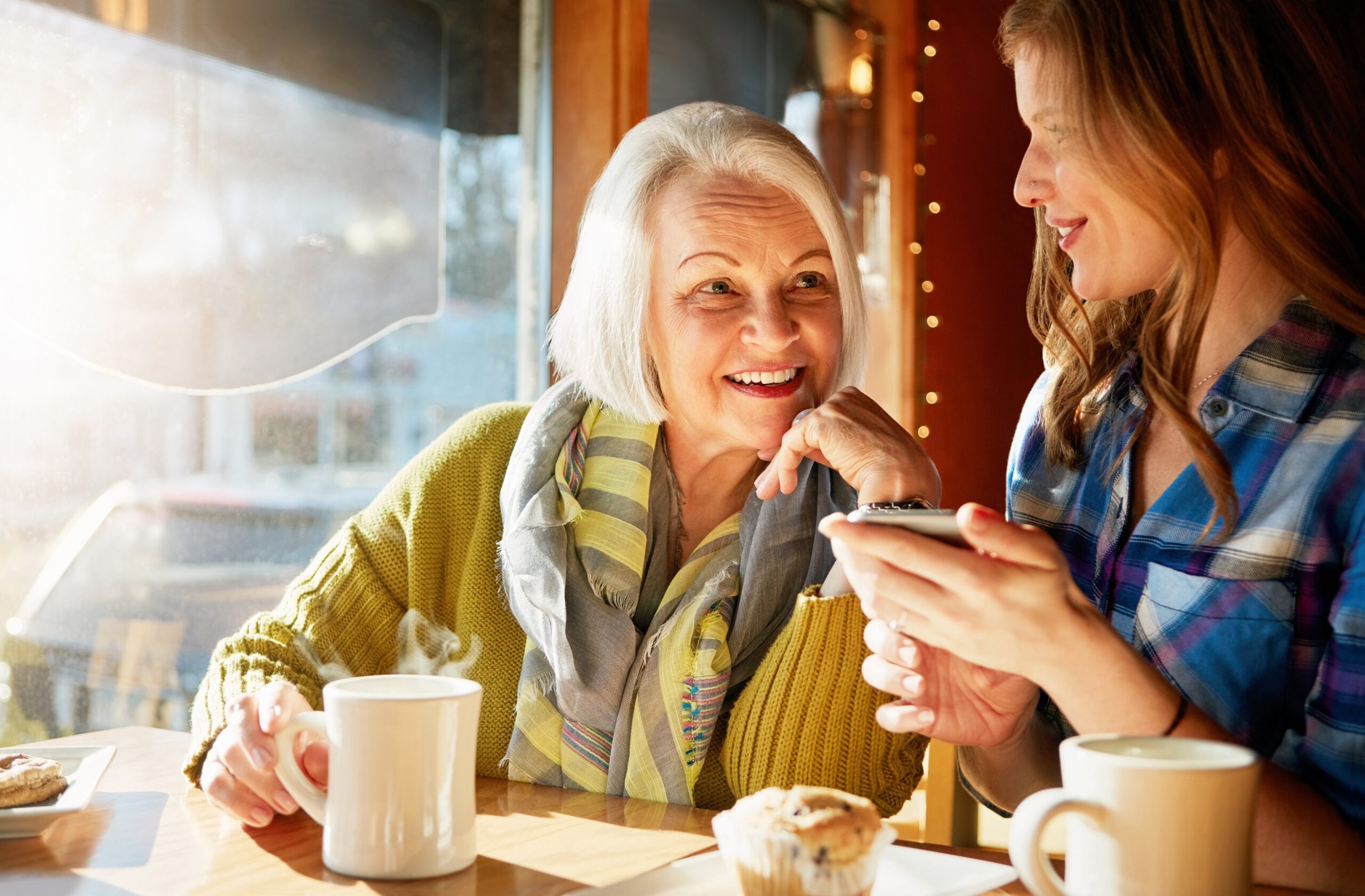 A senior woman enjoying coffee with a friend.