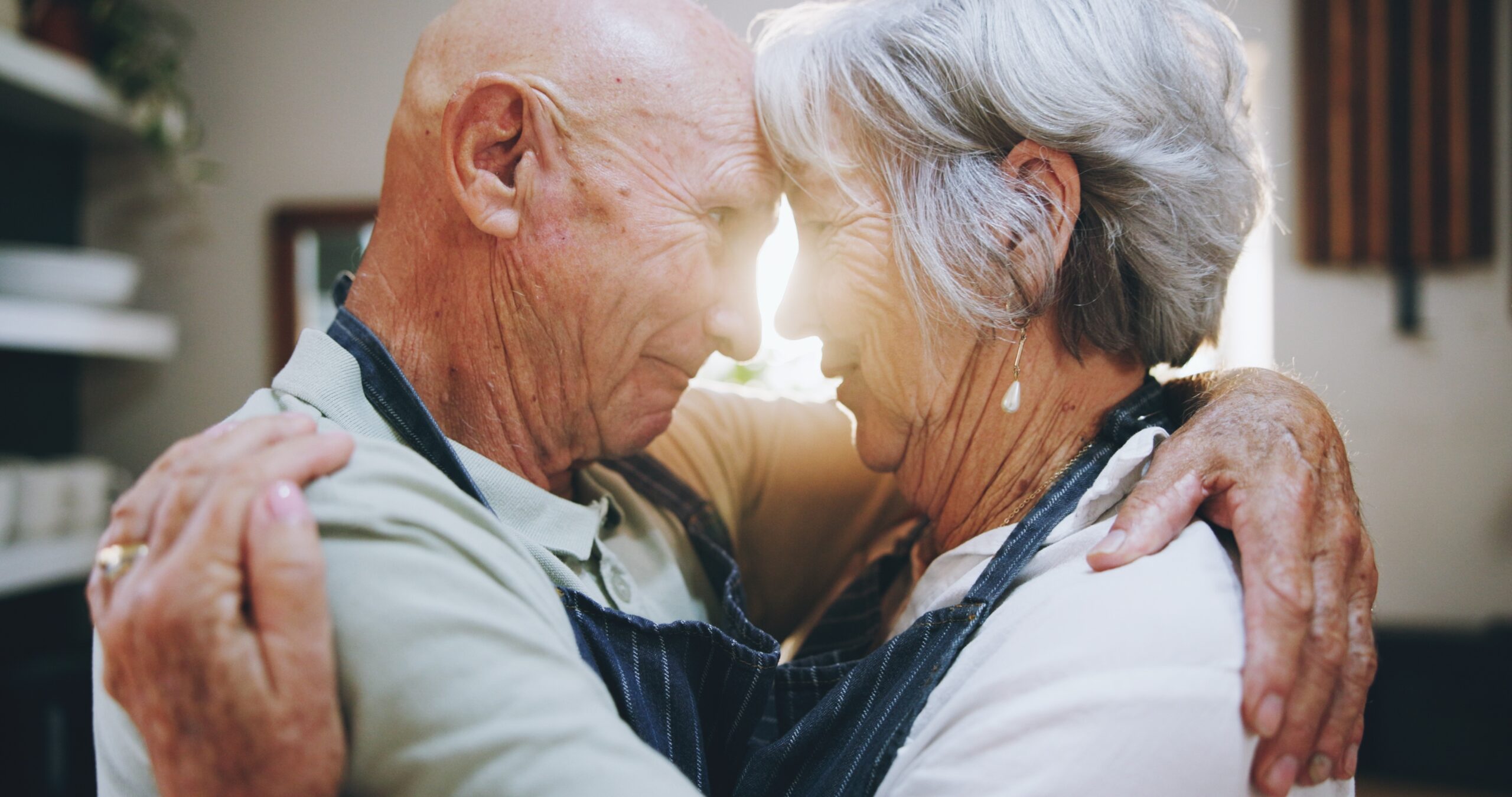 A senior couple embracing.