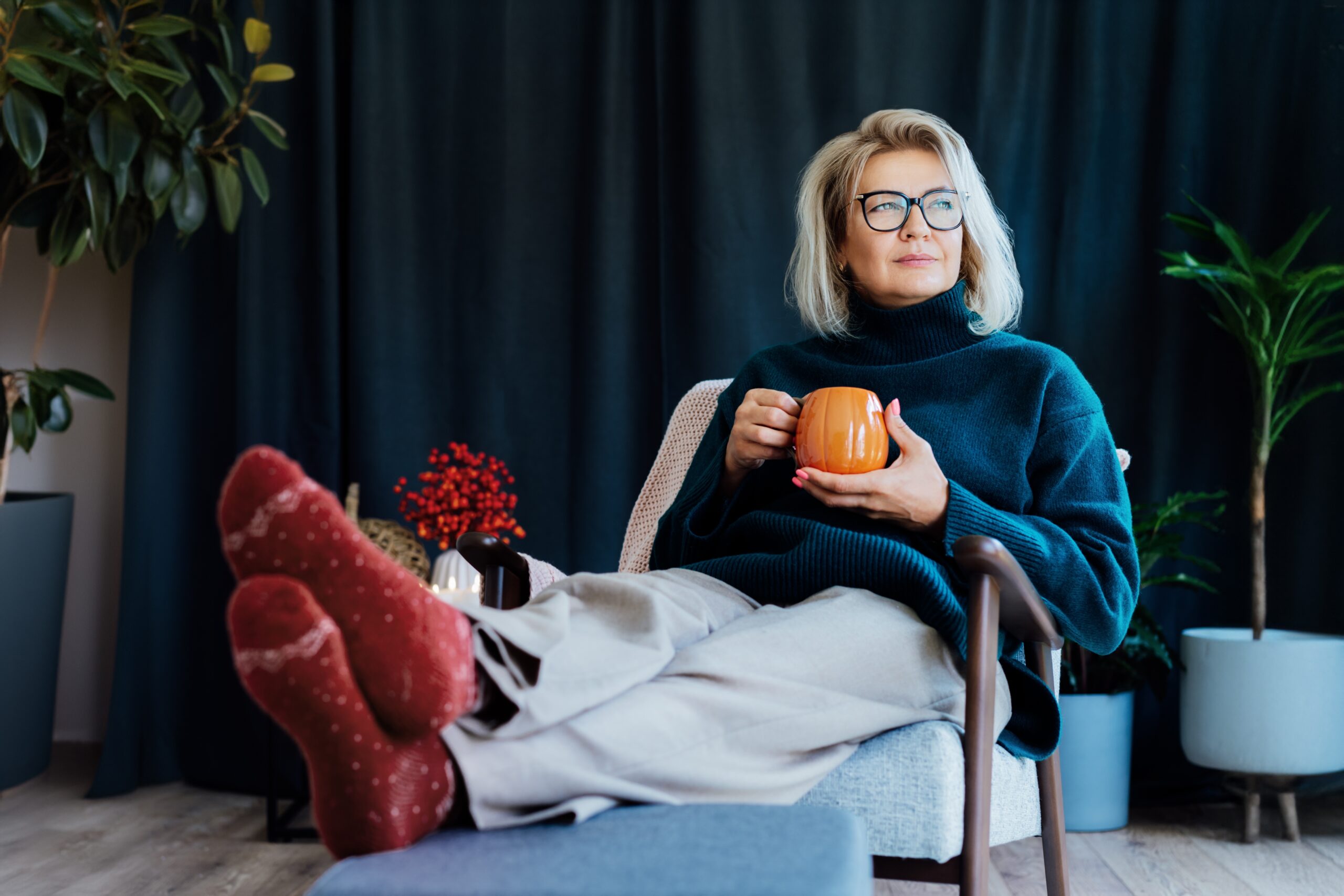 Middle aged woman sitting alone with a cup of coffee.
