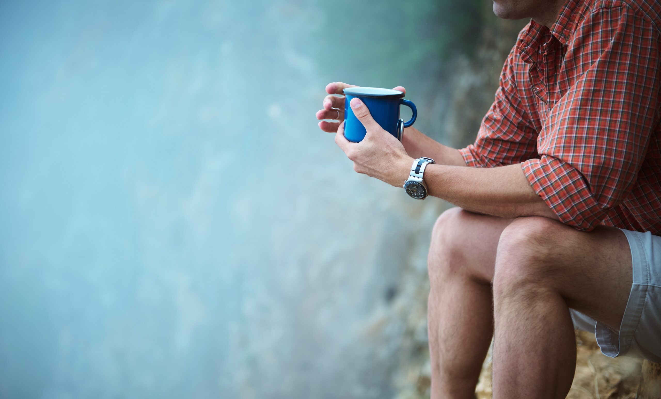 A man sitting alone on a solo camping trip.