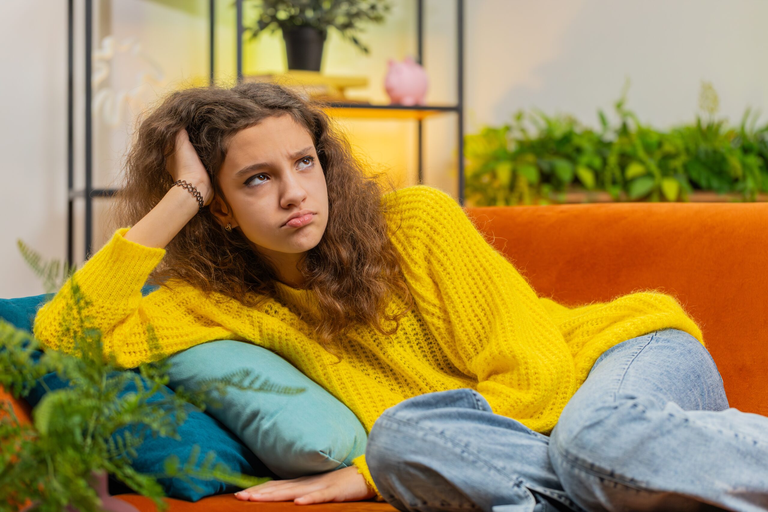 A lonely teenager at home thinking over her life concerns.