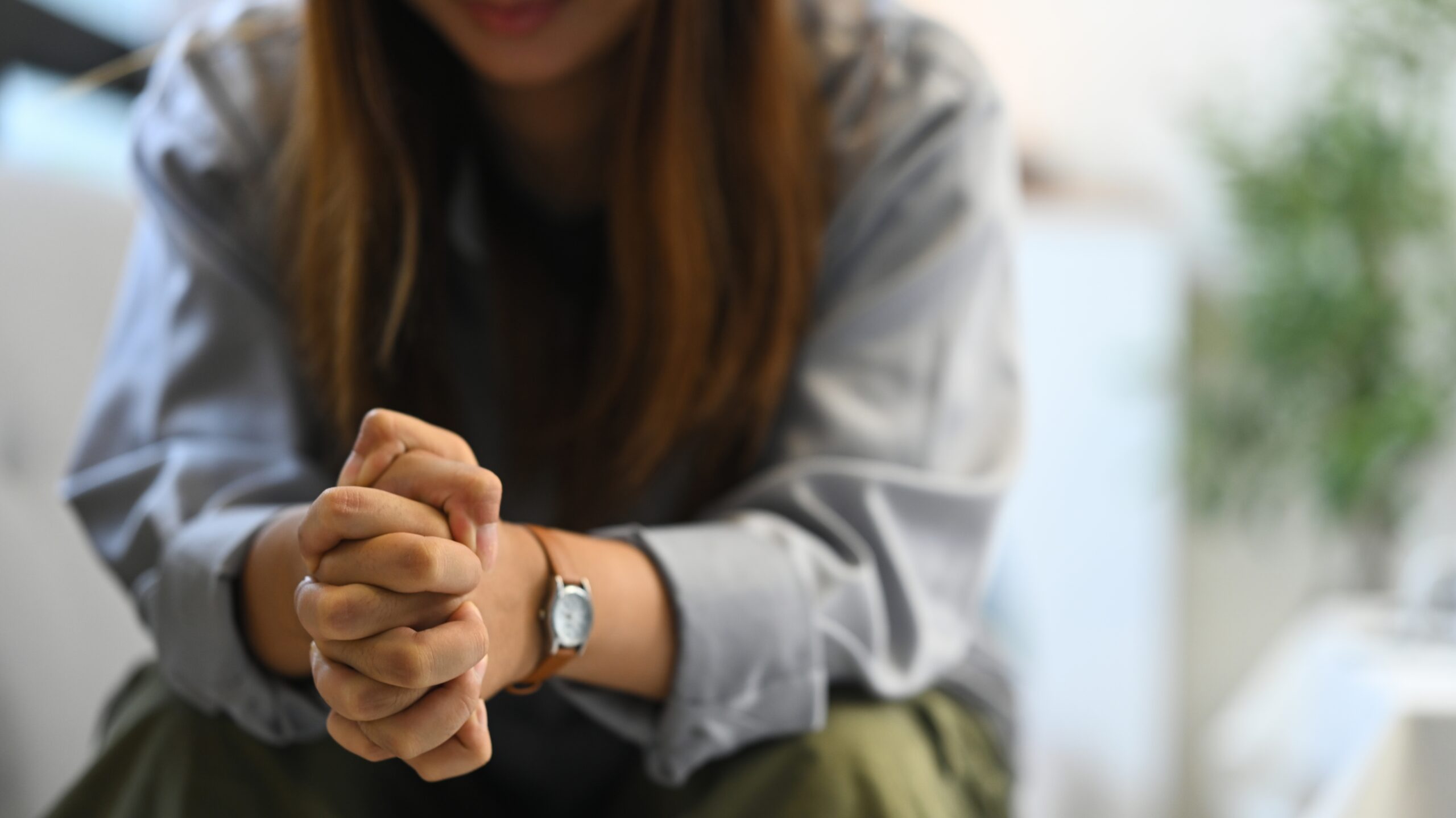 A woman sitting alone feeling protective of her emotions.