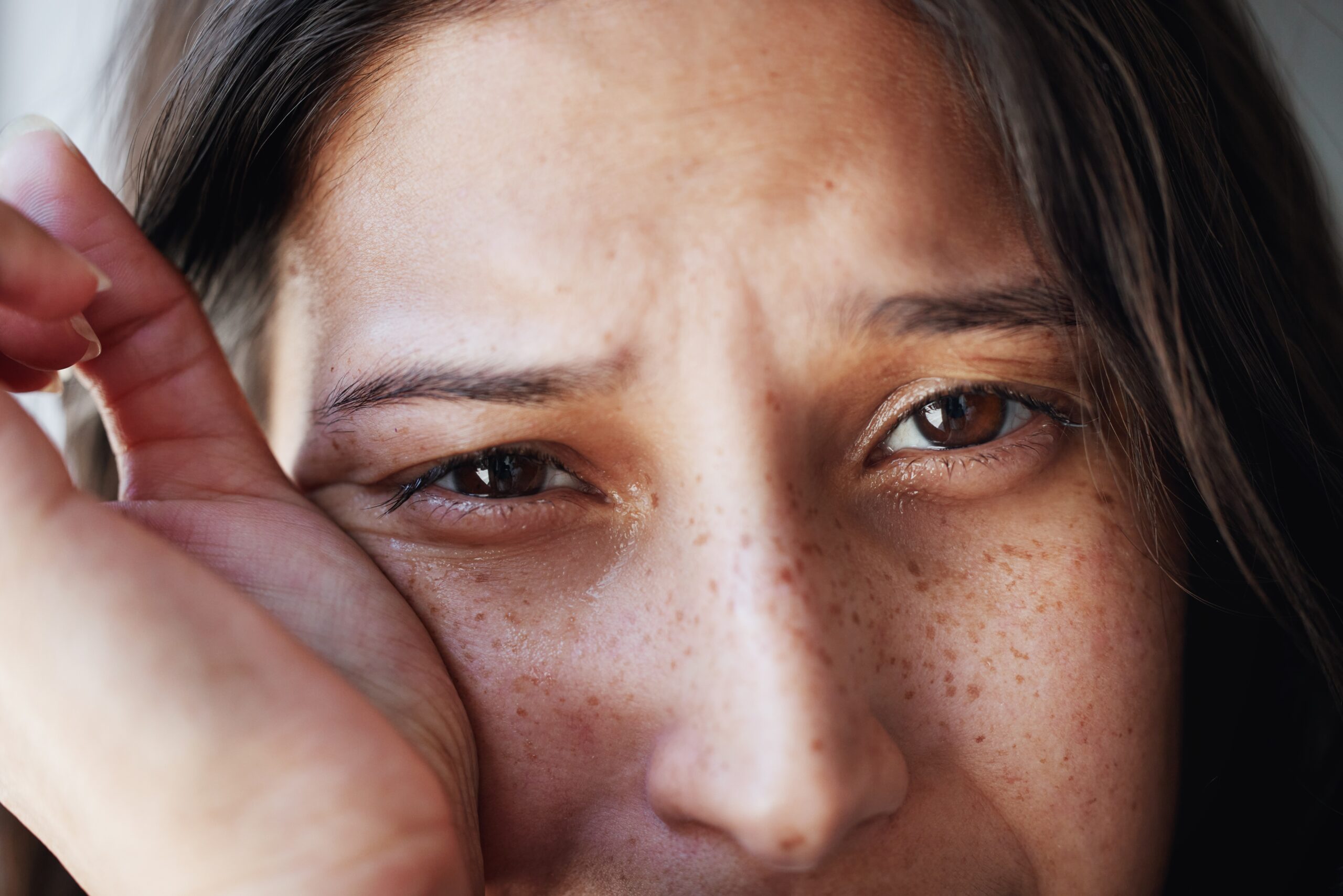 A crying woman dealing with mental health issues.