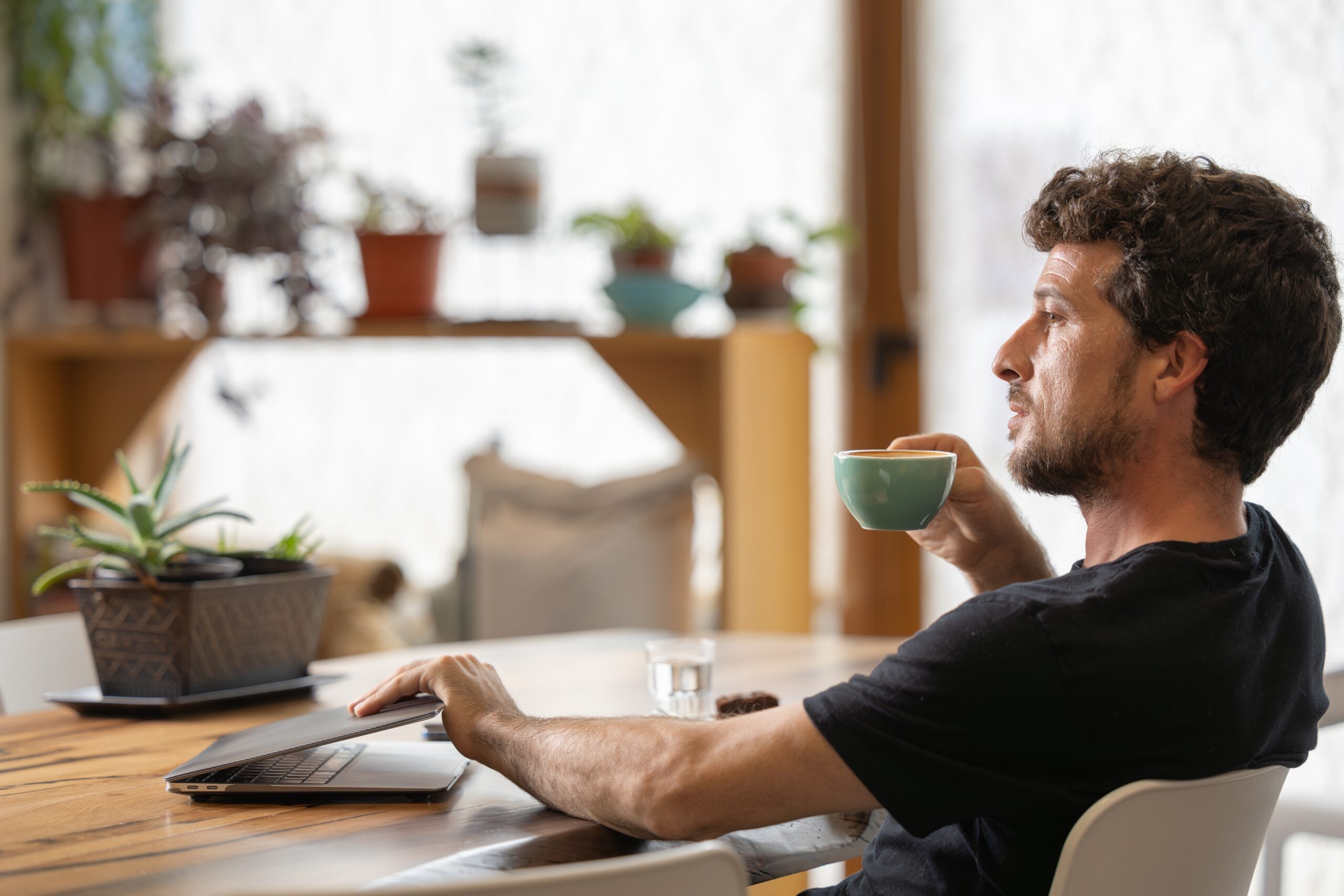 A confident man having coffee at a cafe.