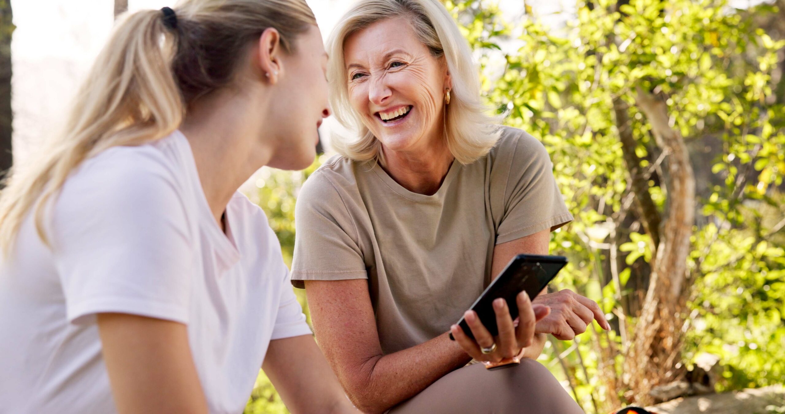 A mature woman with her adult daughter on a nature walk.