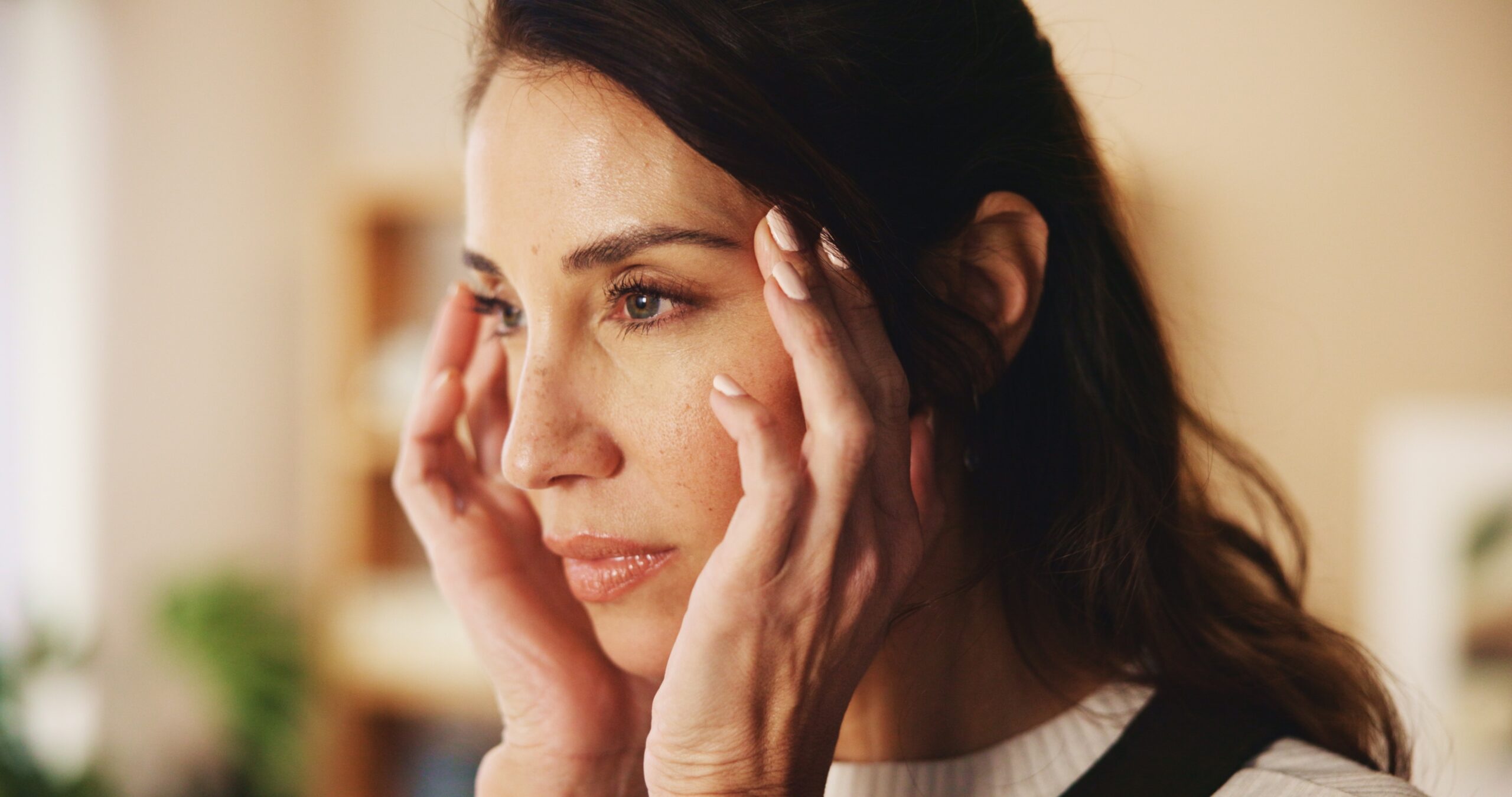 A woman with a stress headache overthinking her emotions.