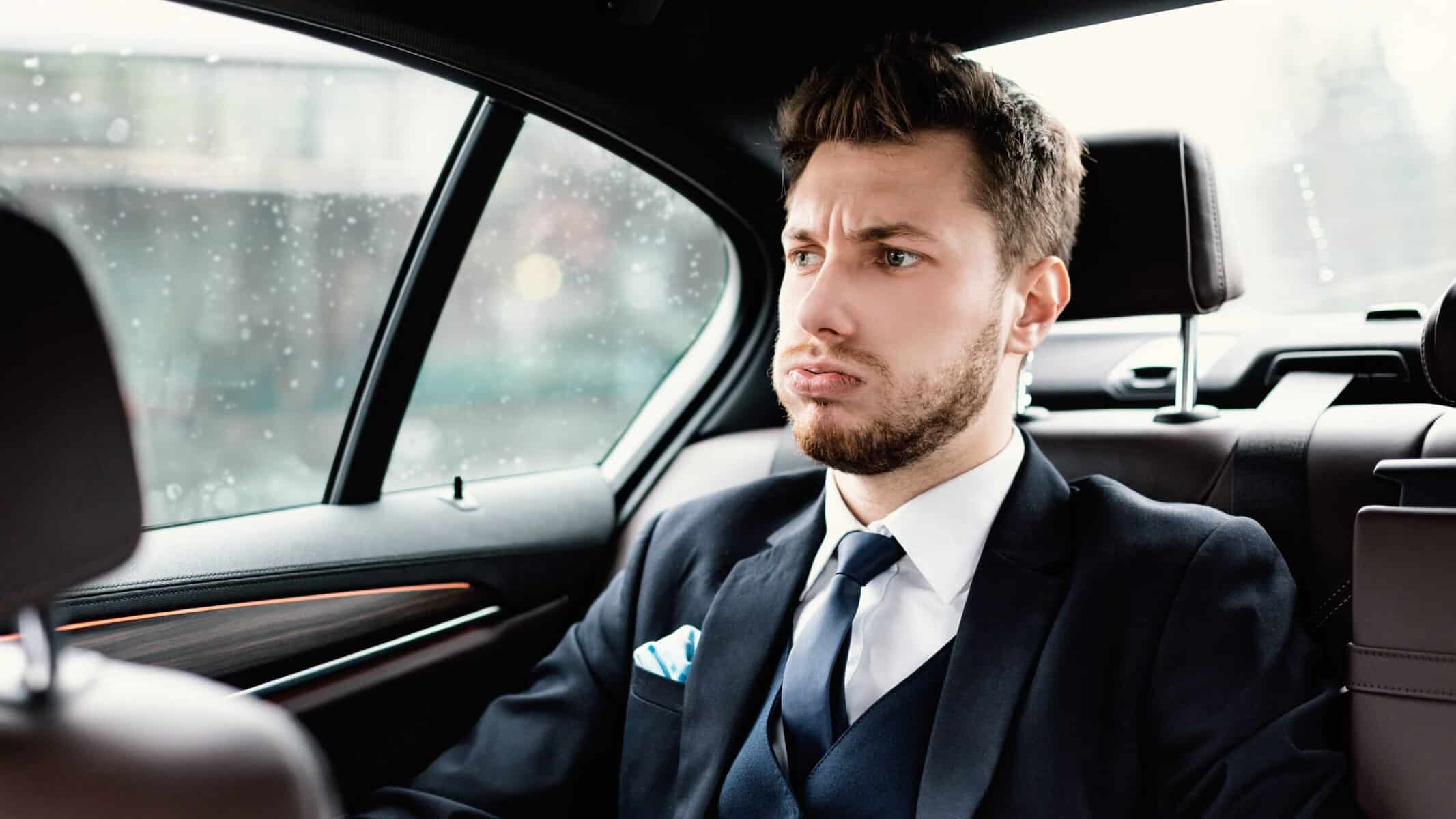 A successful but stressed businessman in his car.