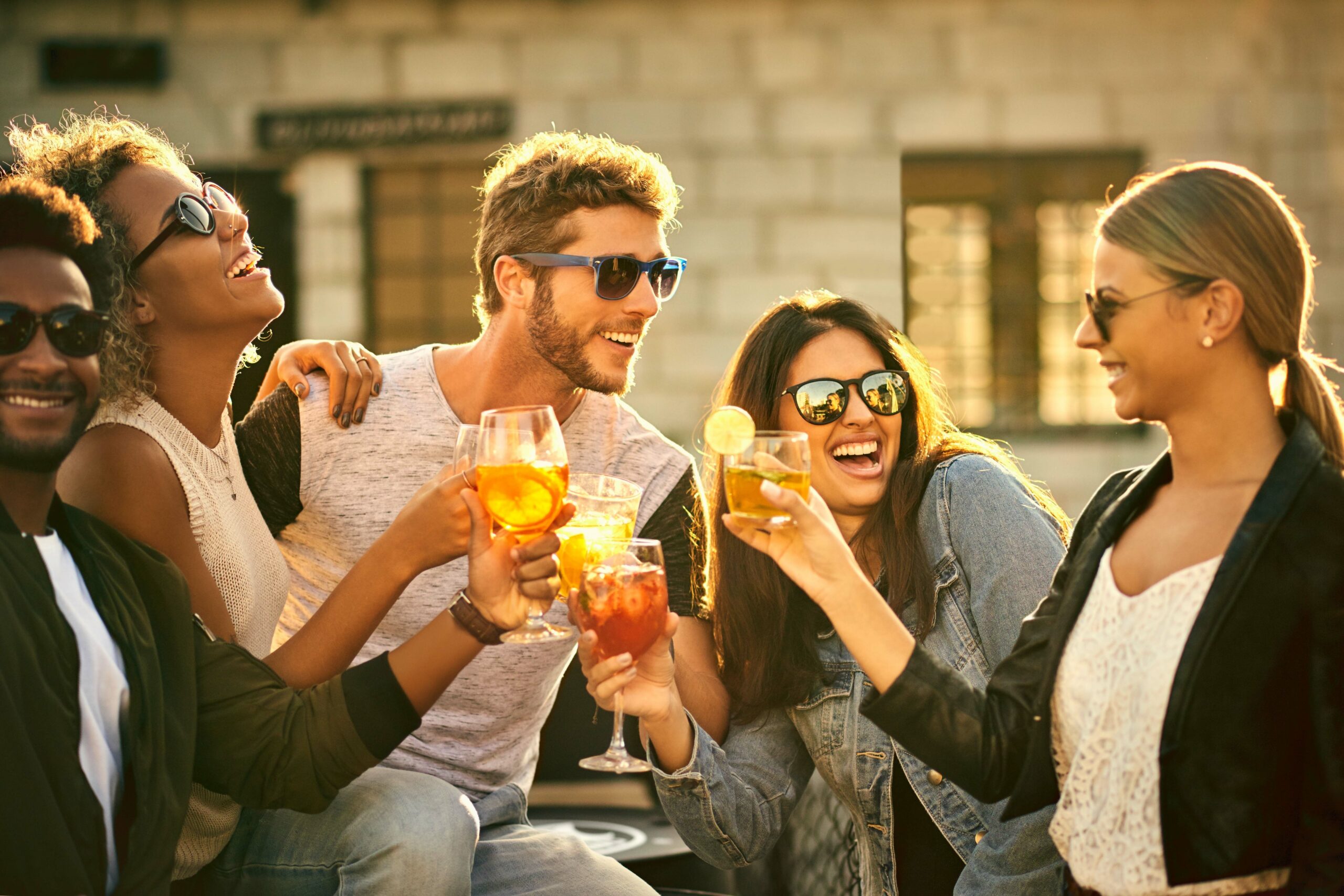 A group of friends centered around a magnetic man at a party.