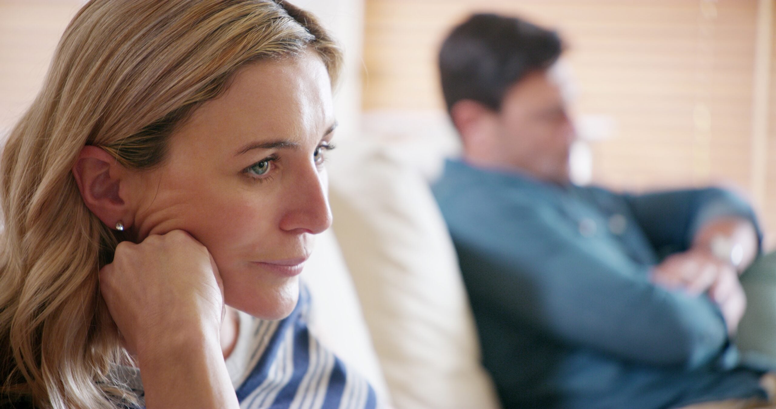 A married couple having a difficult conversation at home.