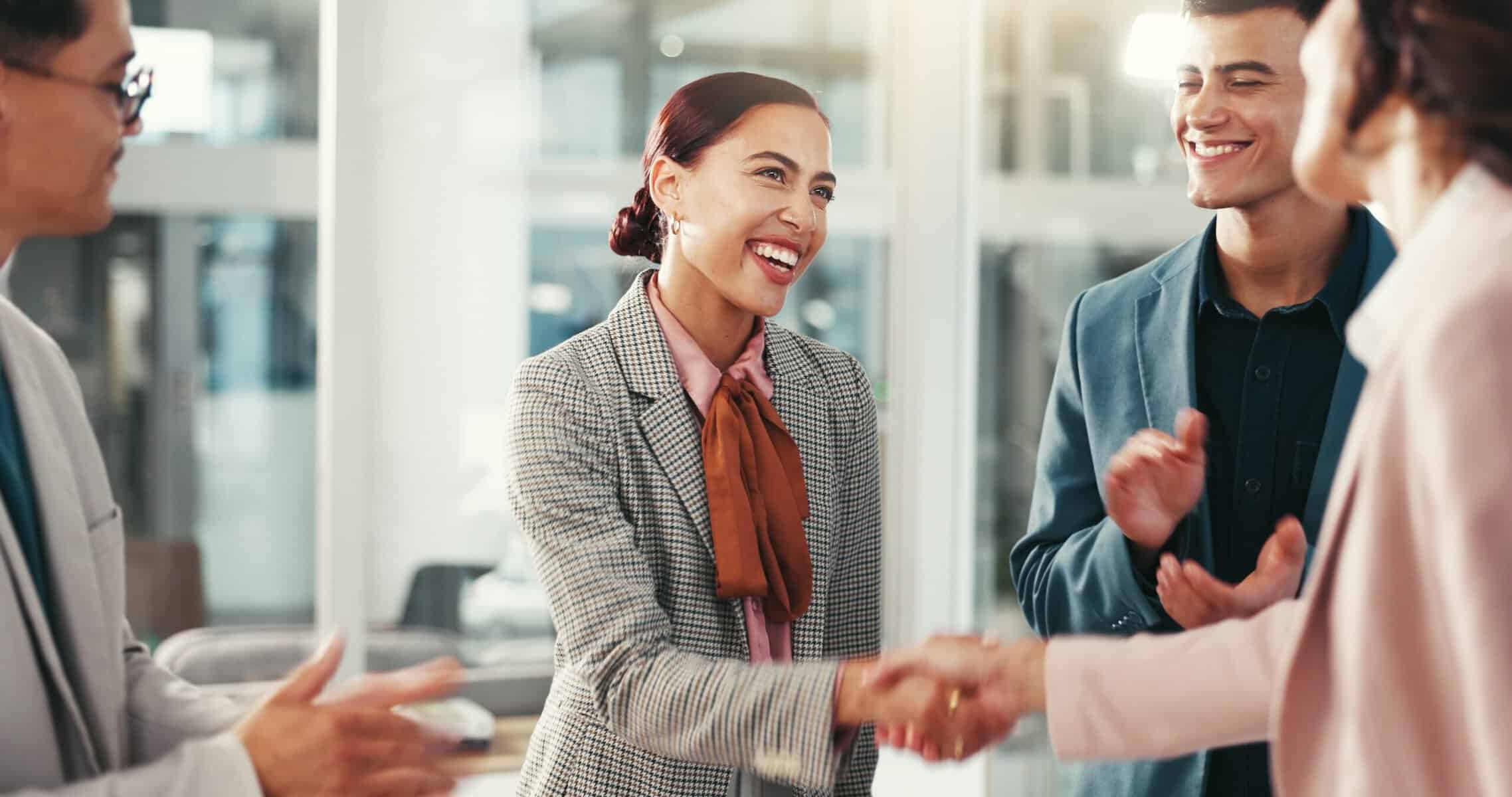 A woman feeling modest over being congratulated on a promotion at work.