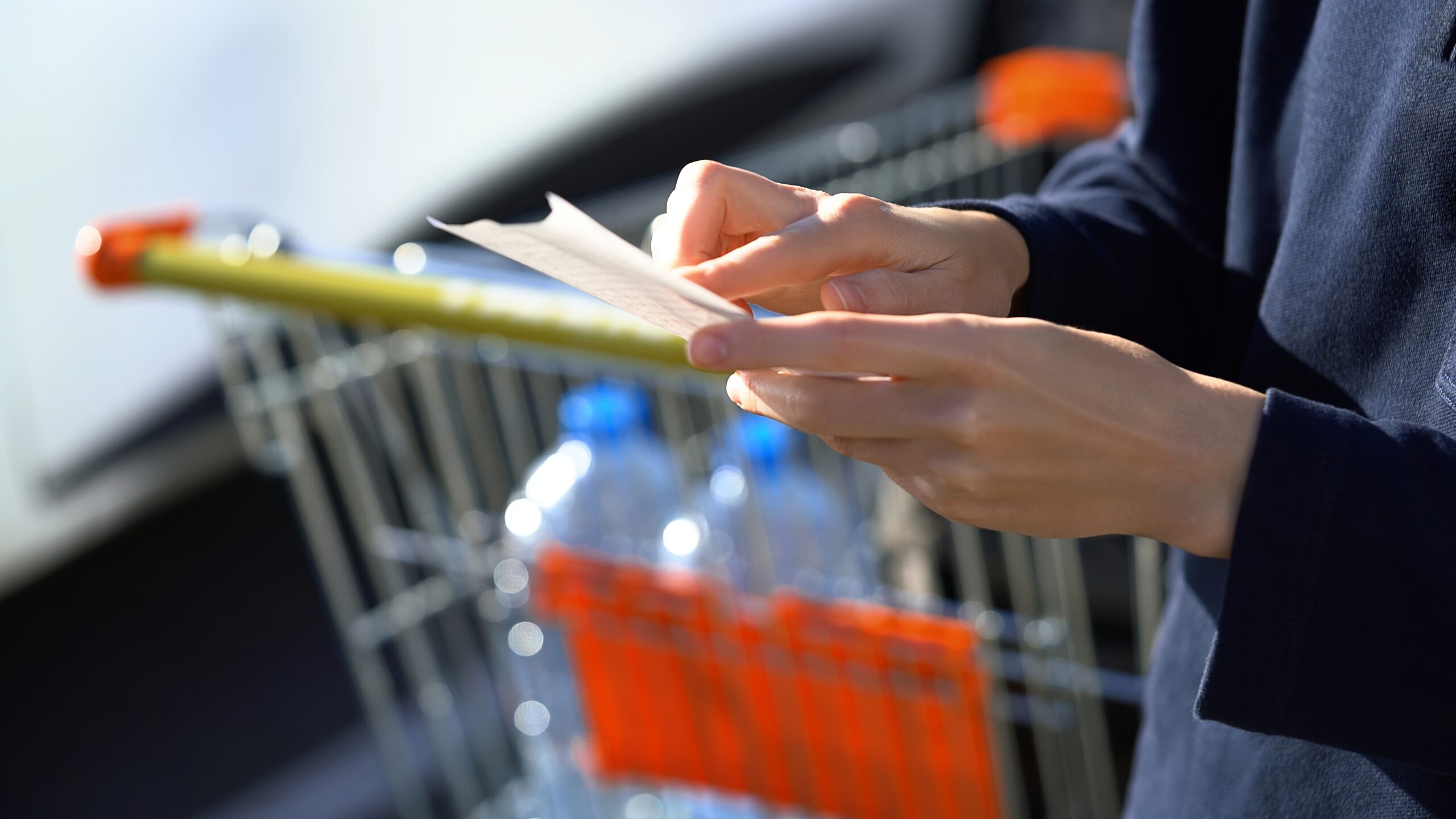 A customer checking the receipt after grocery shopping.
