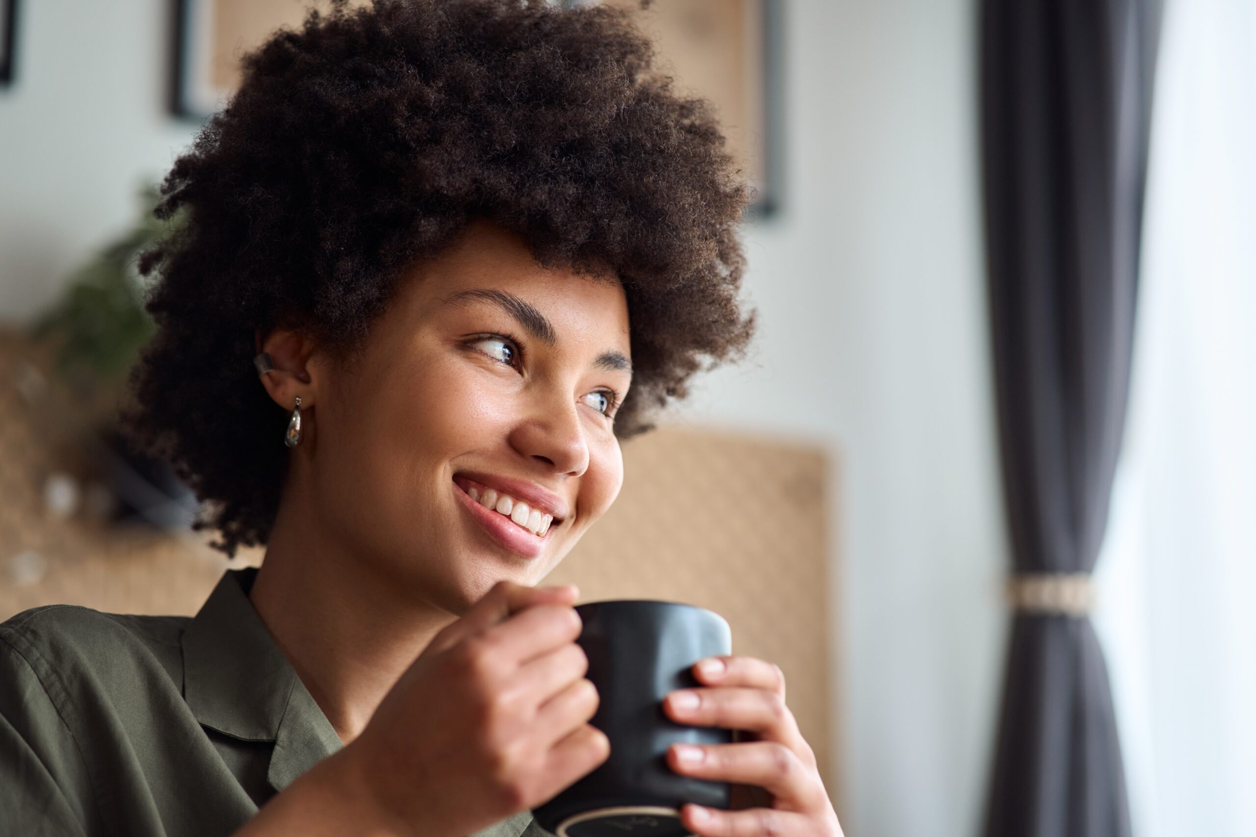 A content woman sitting alone in a cafe.