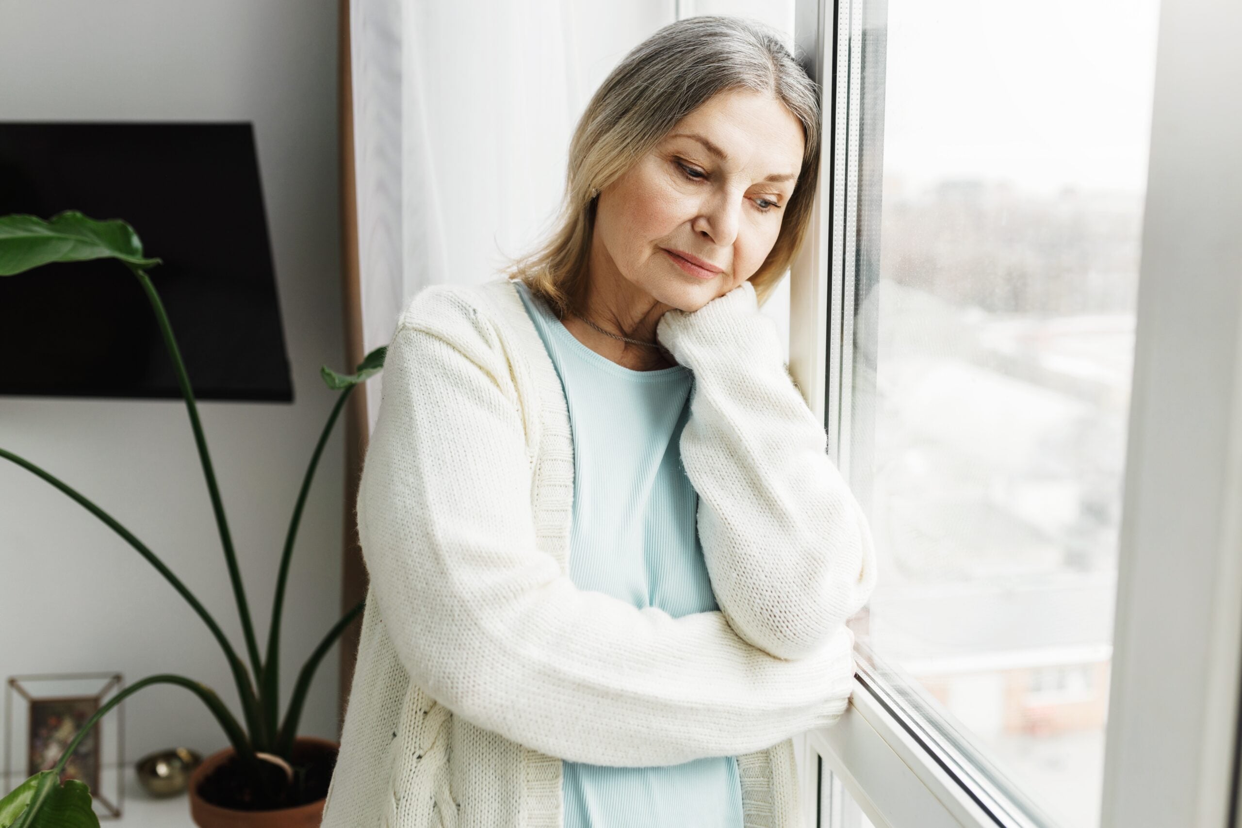 A middle aged woman alone feeling isolated.