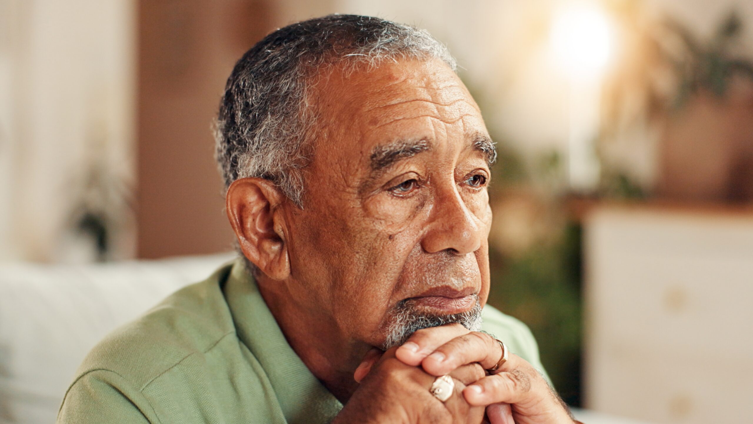 A sad senior man thinking about his passing life.