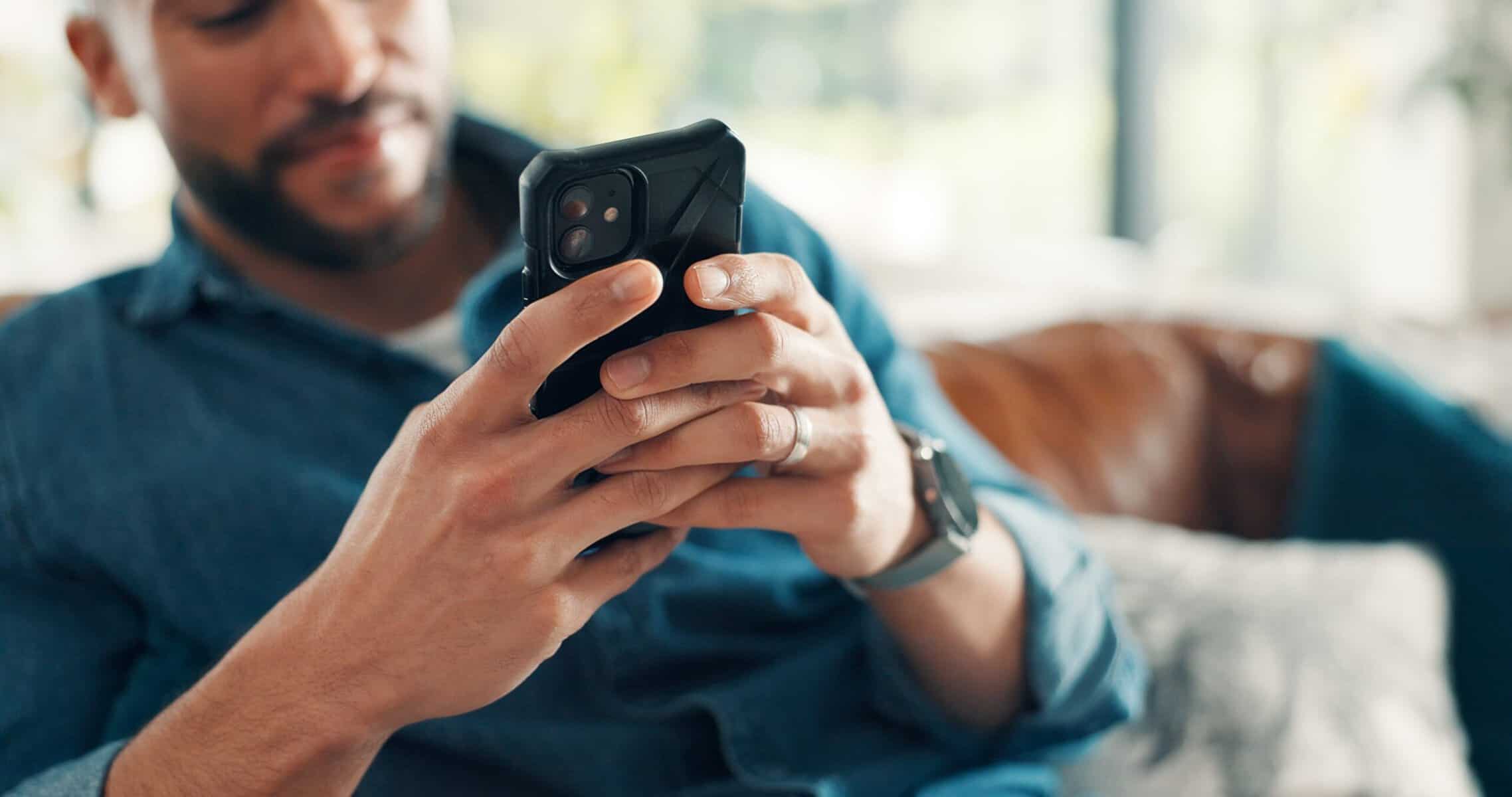 A man is reading his text messages.