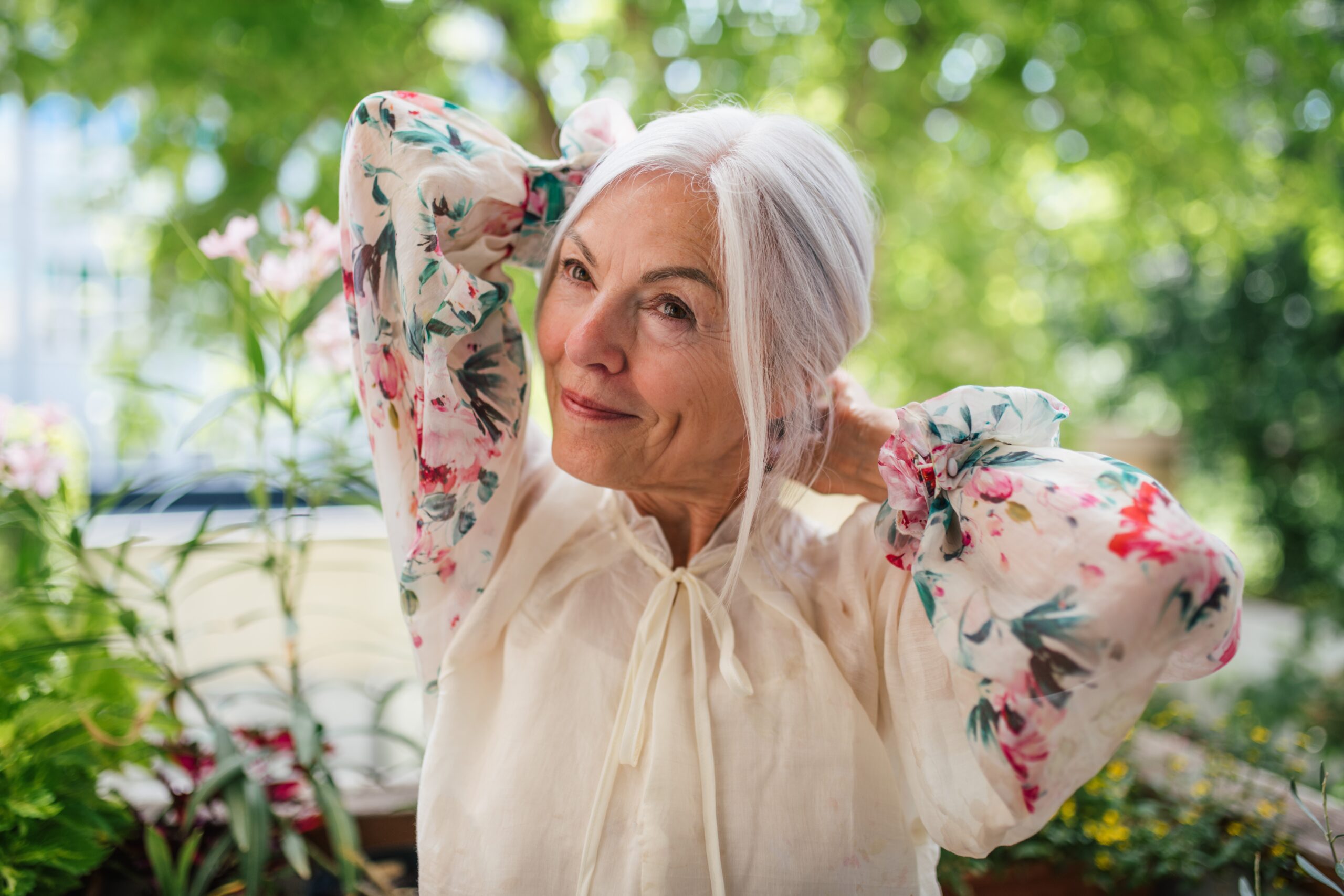 A beautiful and joyful senior woman in a garden.