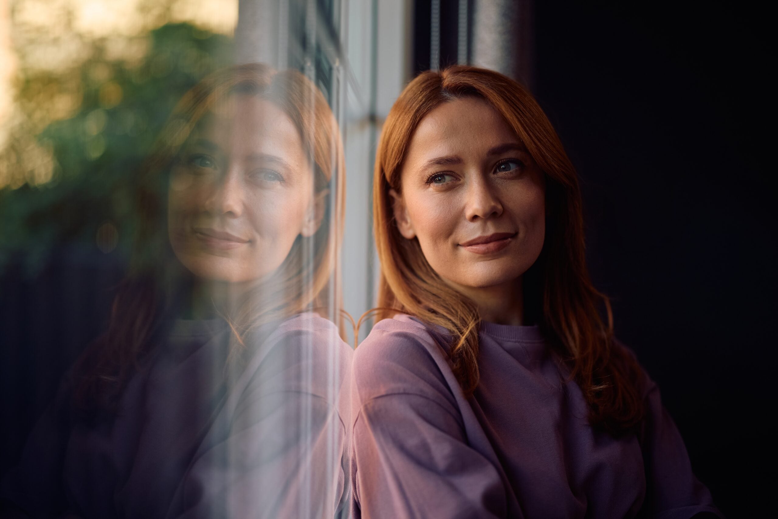 A woman at home feeling vulnerable.