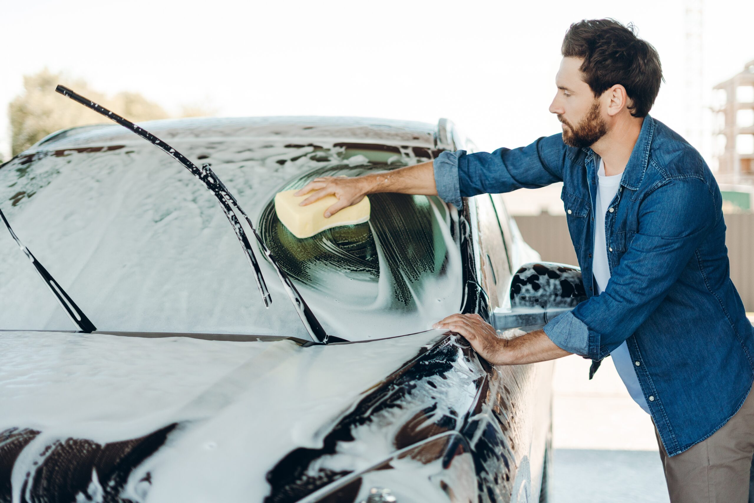 A man washing his car.
