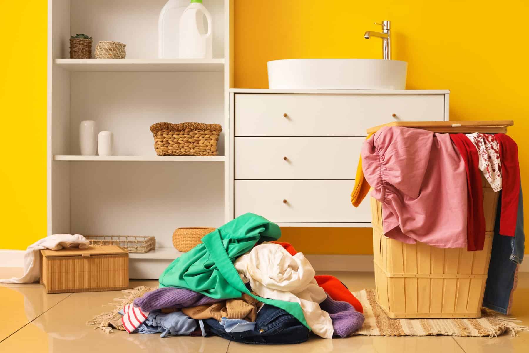 An overflowing laundry pile in a closet.