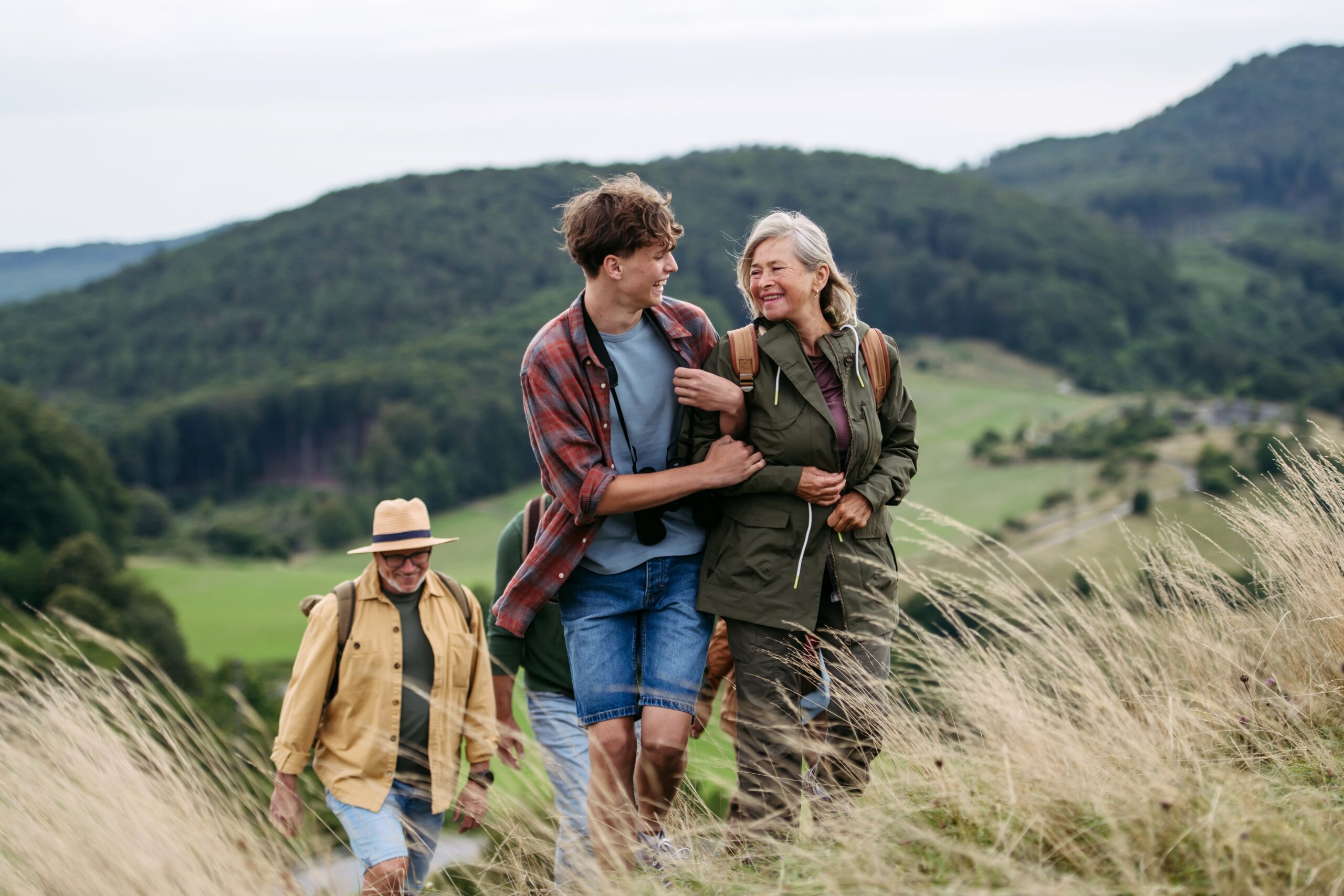 Grandparents and their teen grandson on a hike.