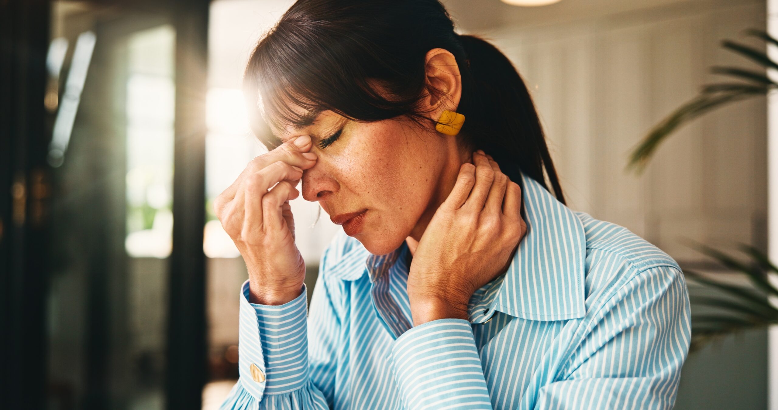 A woman feeling exhaustion from stress.