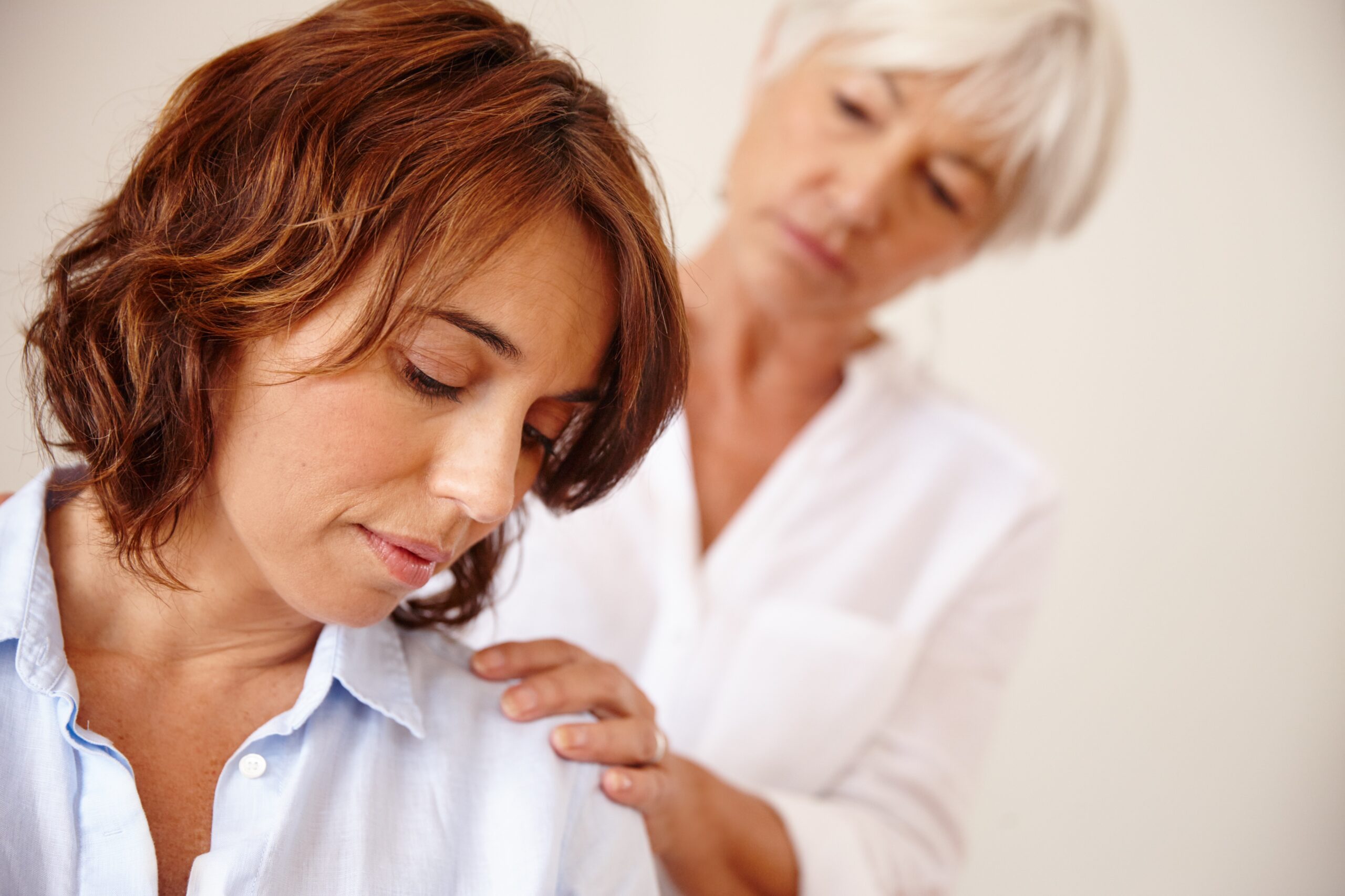 A senior mother having a difficult discussion with her adult daughter.